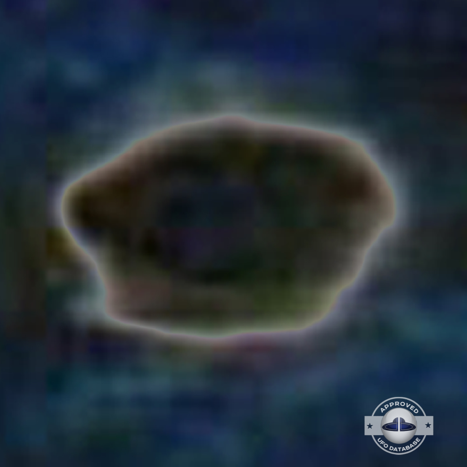 very bright disc-like object remaining stationary near a thunderhead UFO Picture #102-7