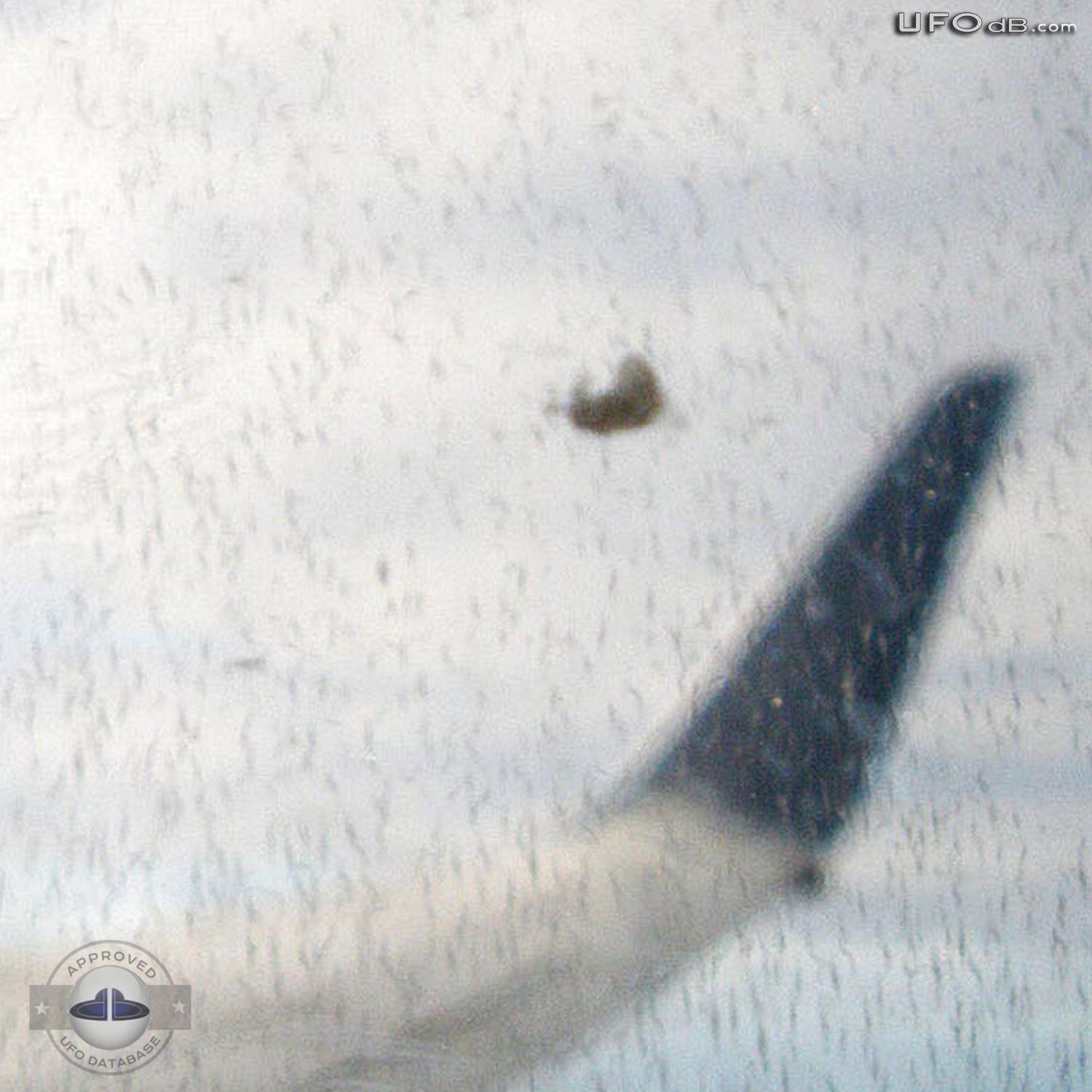 Cloaking UFO near wing of flying Airplane in Australia | January 2011 UFO Picture #243-3