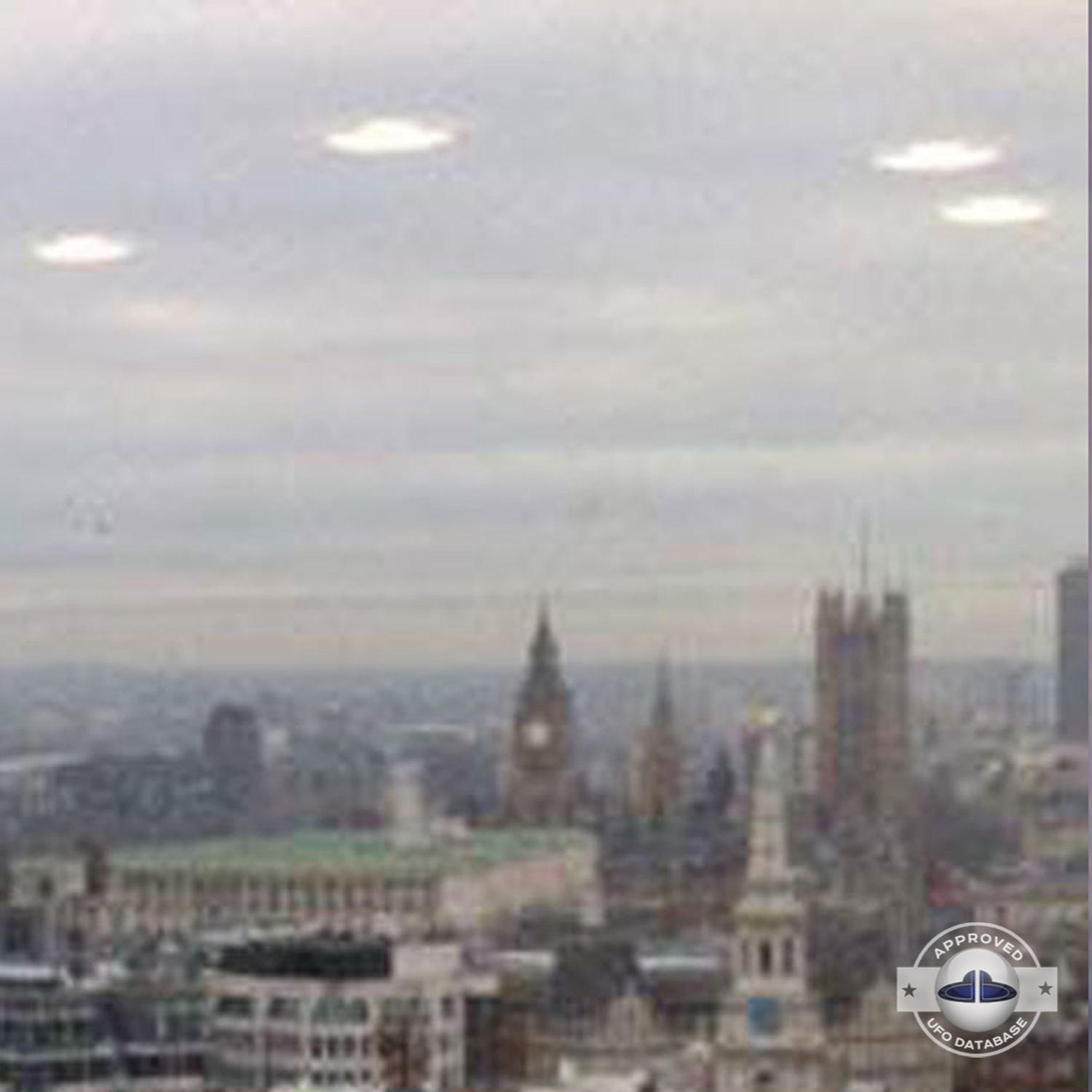 UFO picture we can see 4 white rounds coming out of the grey clouds UFO Picture #60-4