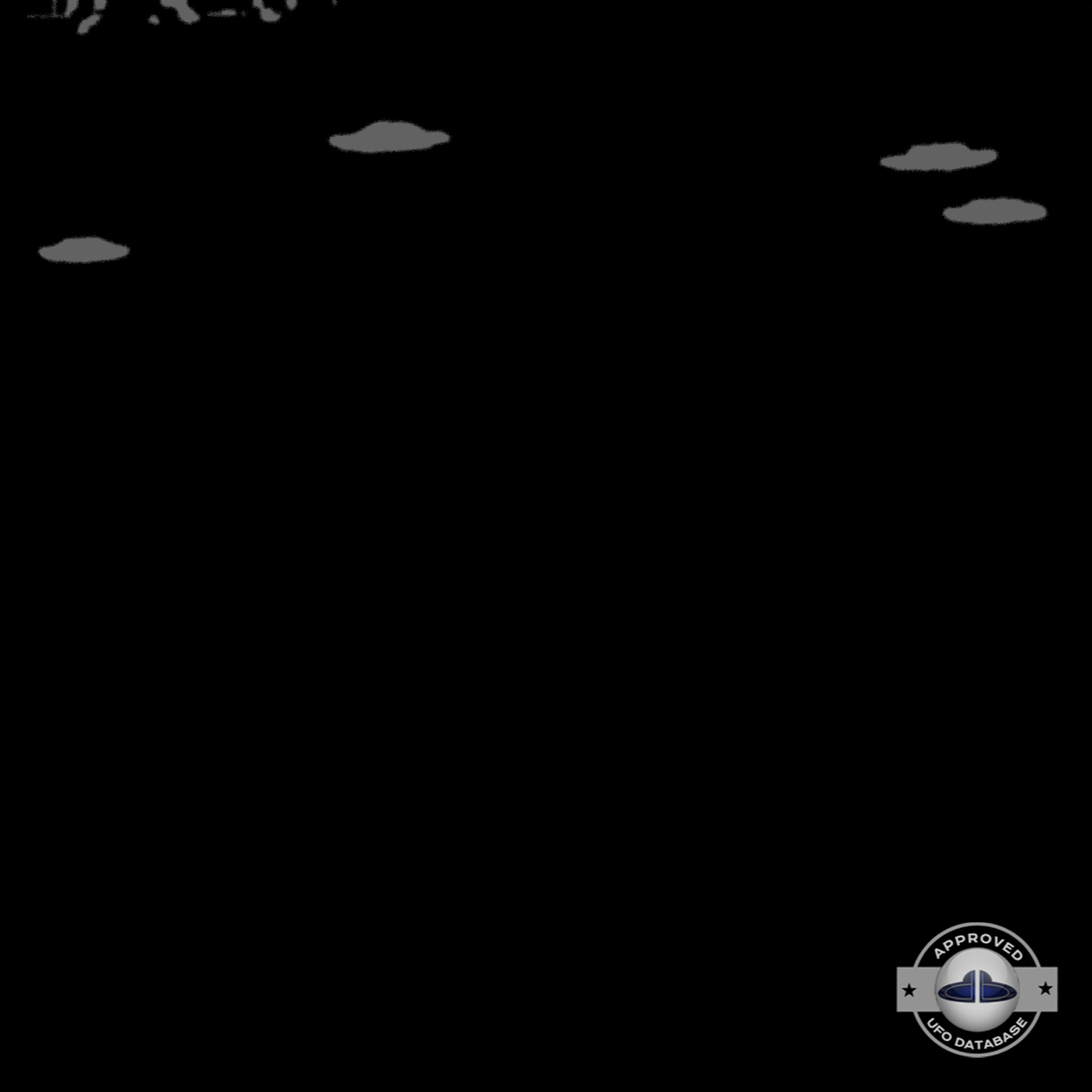UFO picture we can see 4 white rounds coming out of the grey clouds UFO Picture #60-6