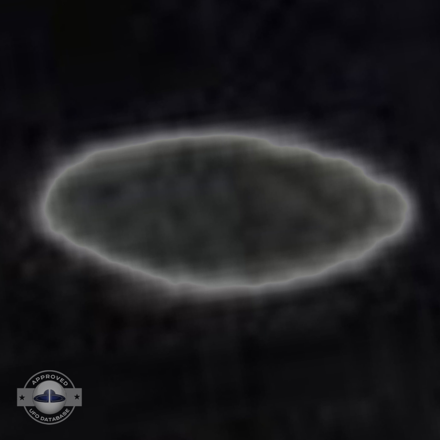 Saucer shaped UFO passing over buildings in Kaizuka on a cloudy day UFO Picture #128-6