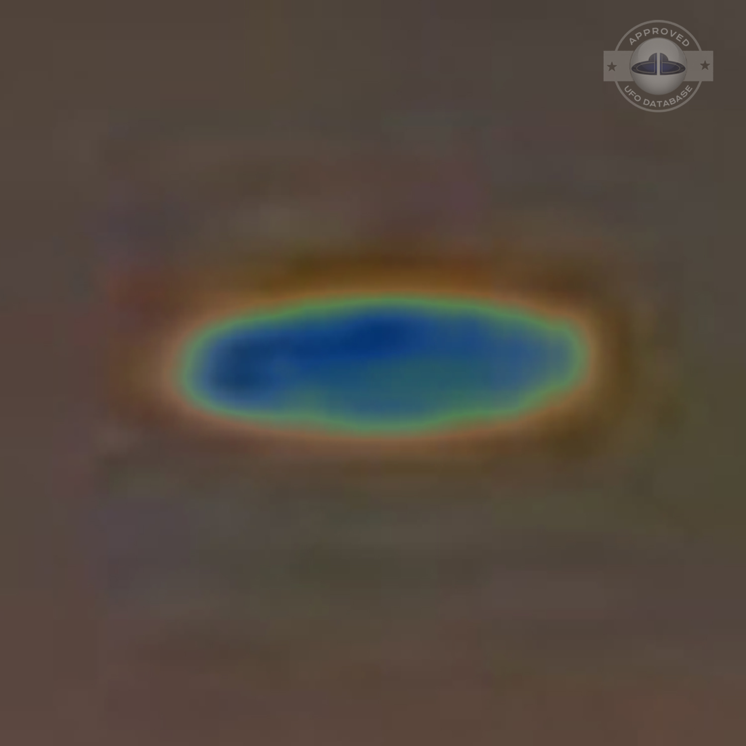 UFO picture showing a bright flat round disc passing near a building UFO Picture #54-7