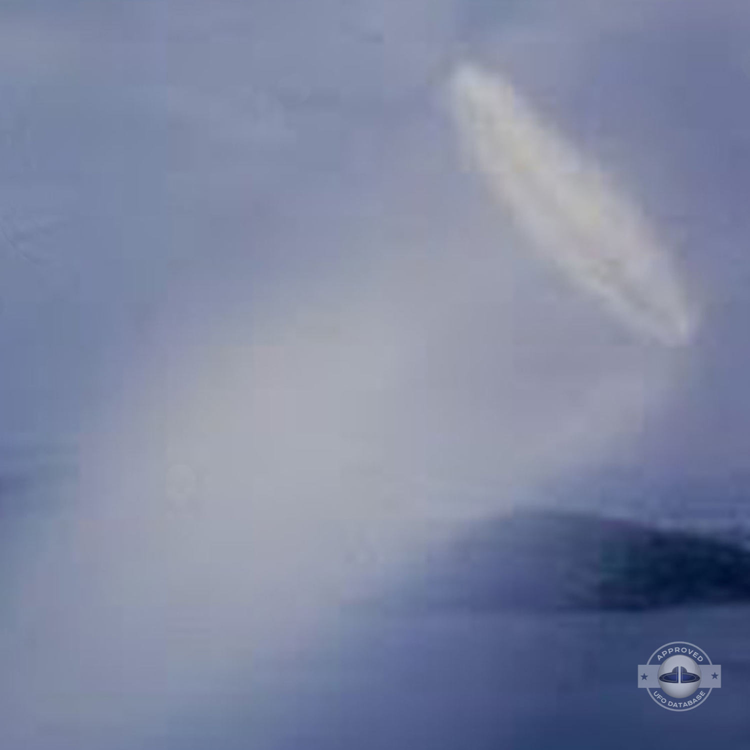 UFO almost sideways over buildings leaving a white gaseous trail 1957 UFO Picture #124-3