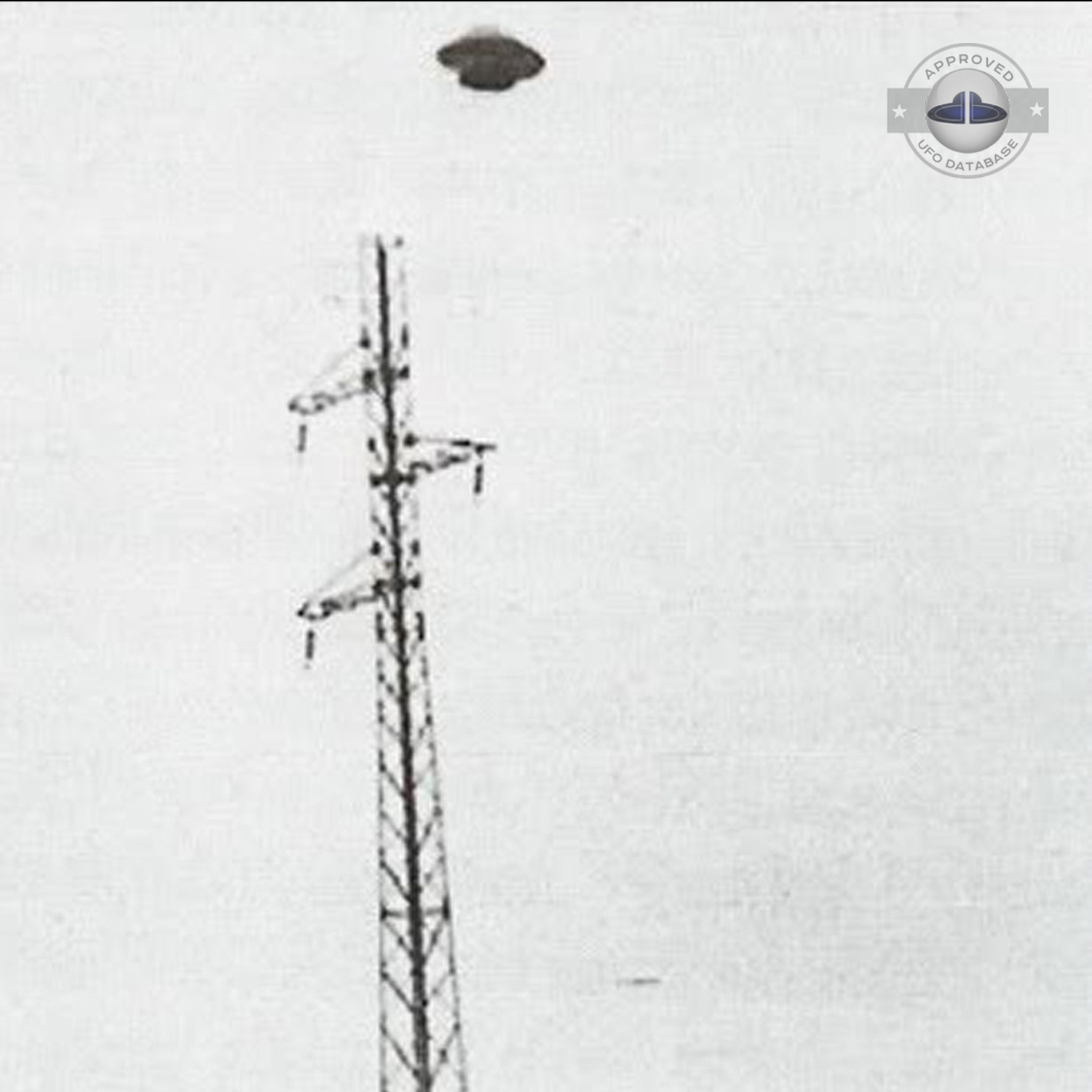 UFO muffin shape flying saucer standing over electrical stucture UFO Picture #46-2