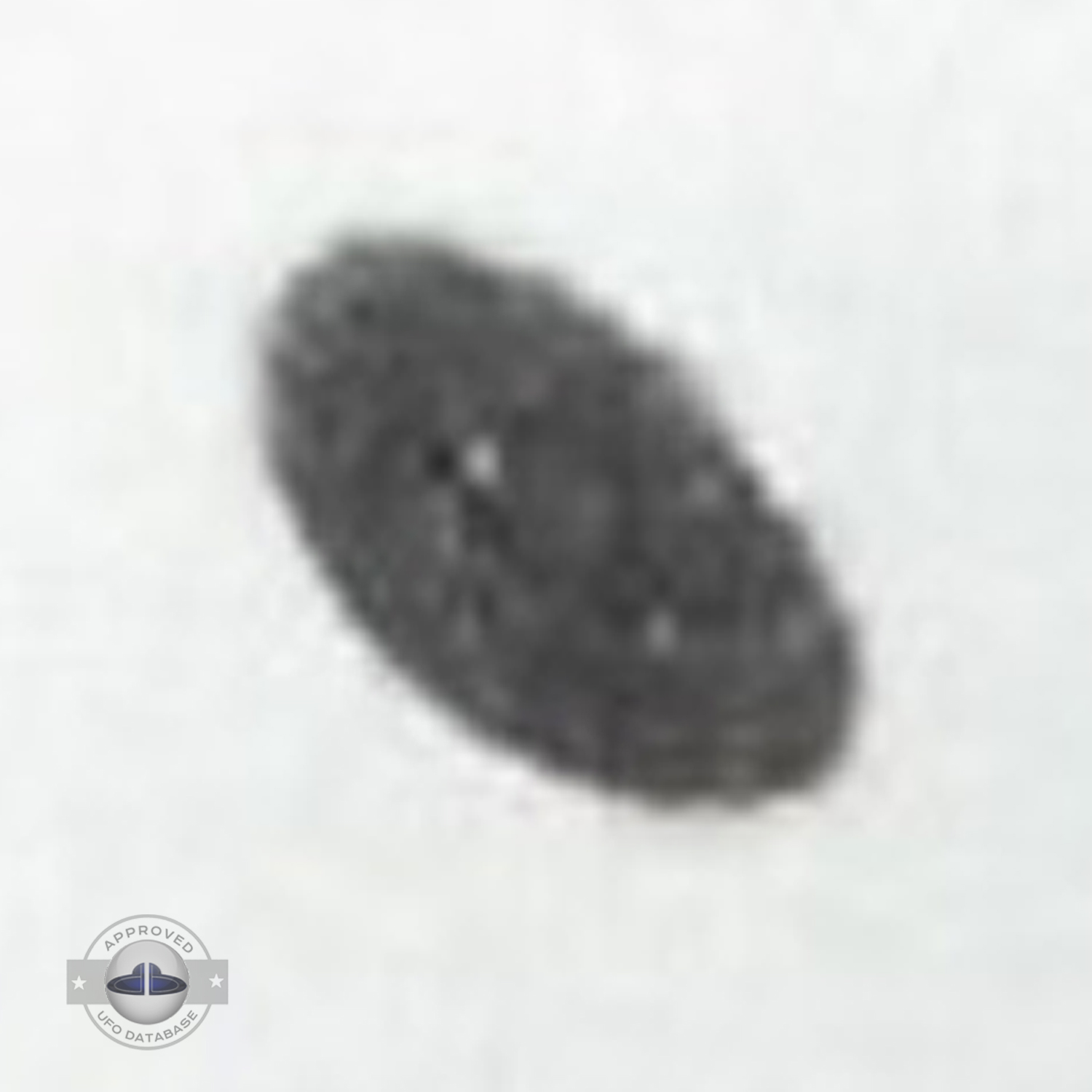 Grey UFO picture UFO high in the sky over buildings and mountains UFO Picture #106-4