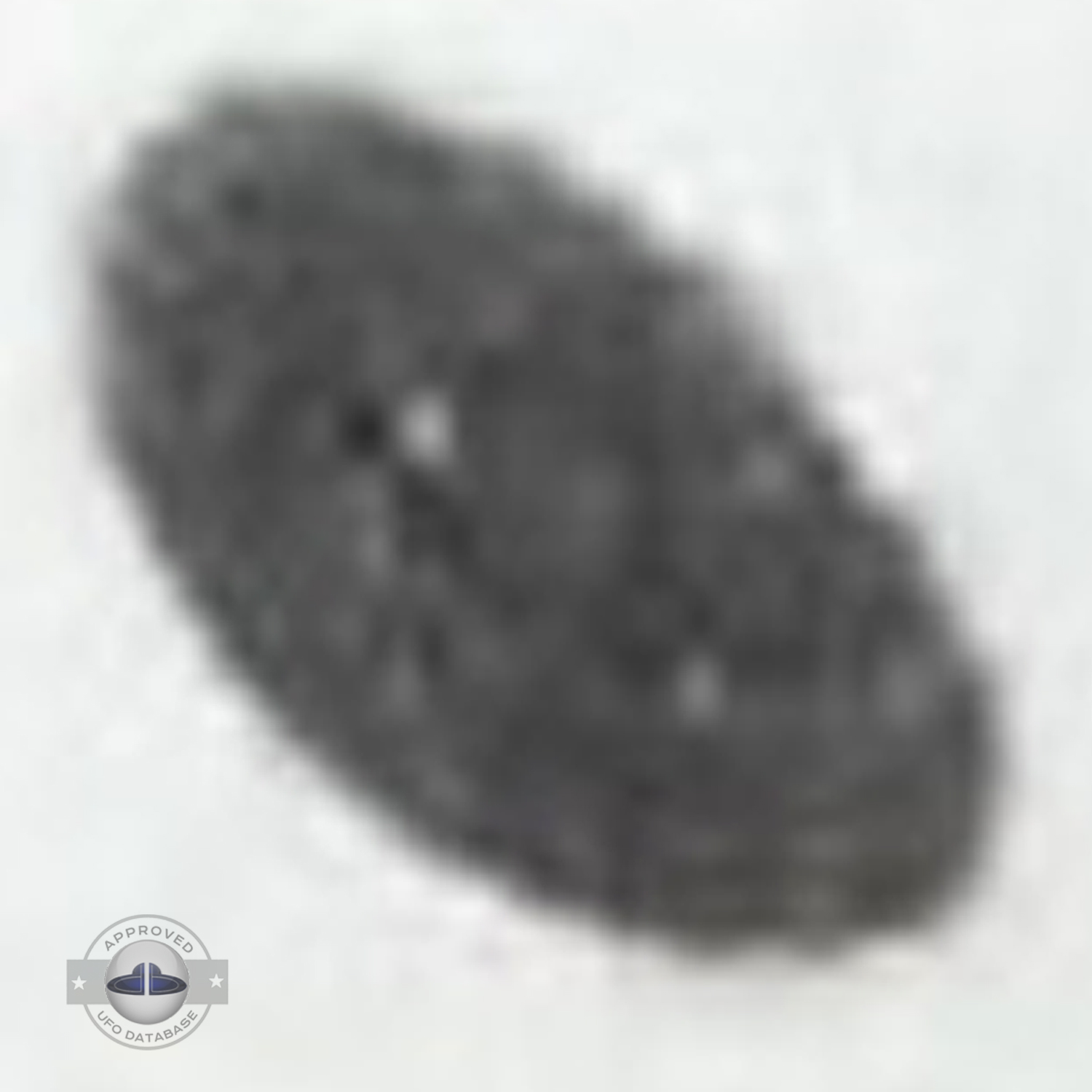 Grey UFO picture UFO high in the sky over buildings and mountains UFO Picture #106-5