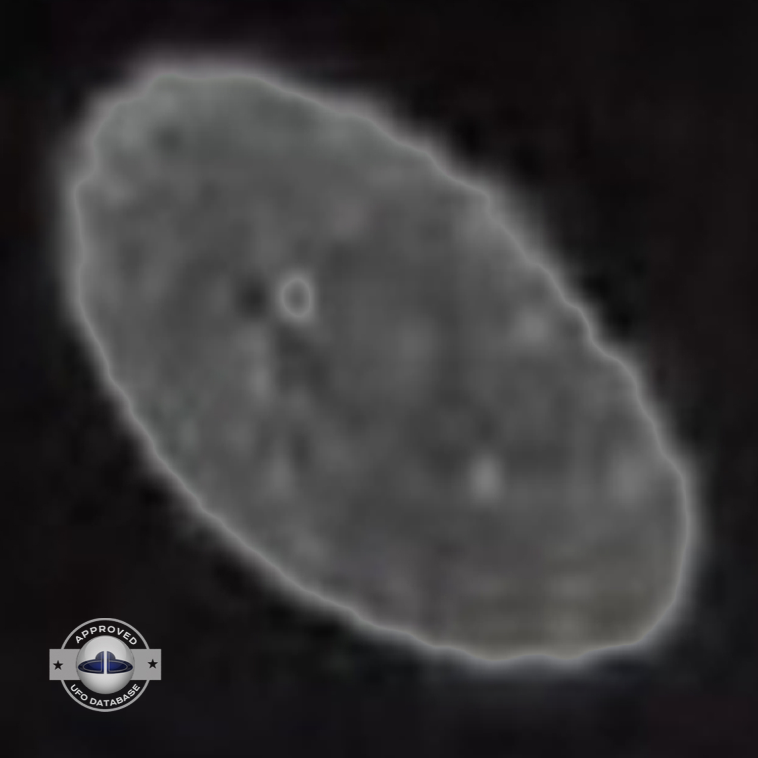 Grey UFO picture UFO high in the sky over buildings and mountains UFO Picture #106-6