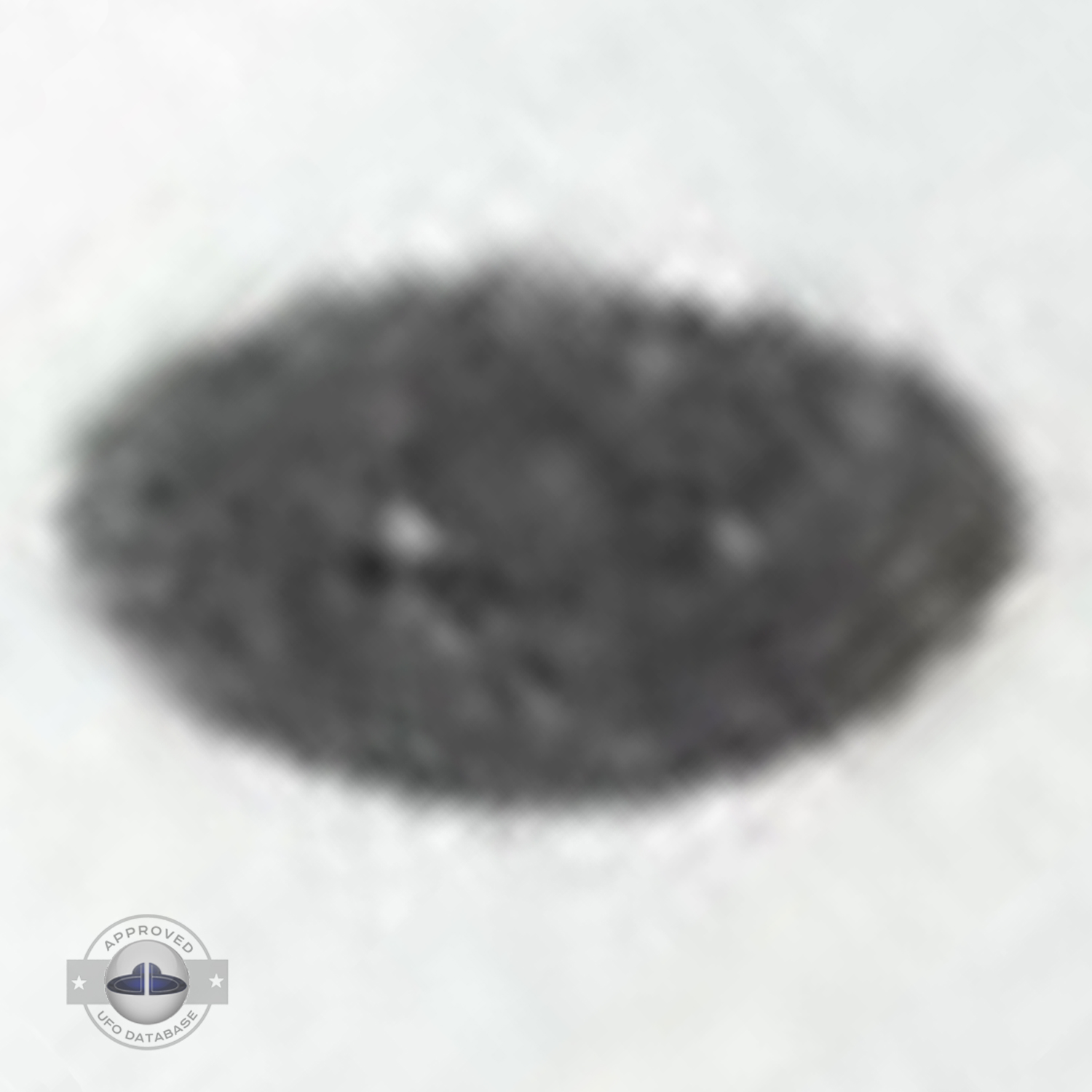 Grey UFO picture UFO high in the sky over buildings and mountains UFO Picture #106-7
