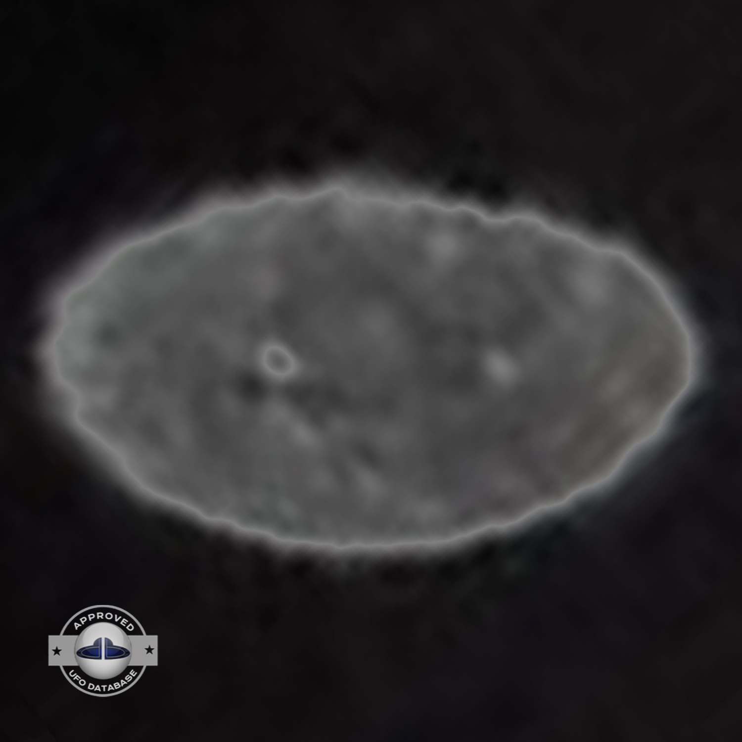 Grey UFO picture UFO high in the sky over buildings and mountains UFO Picture #106-8