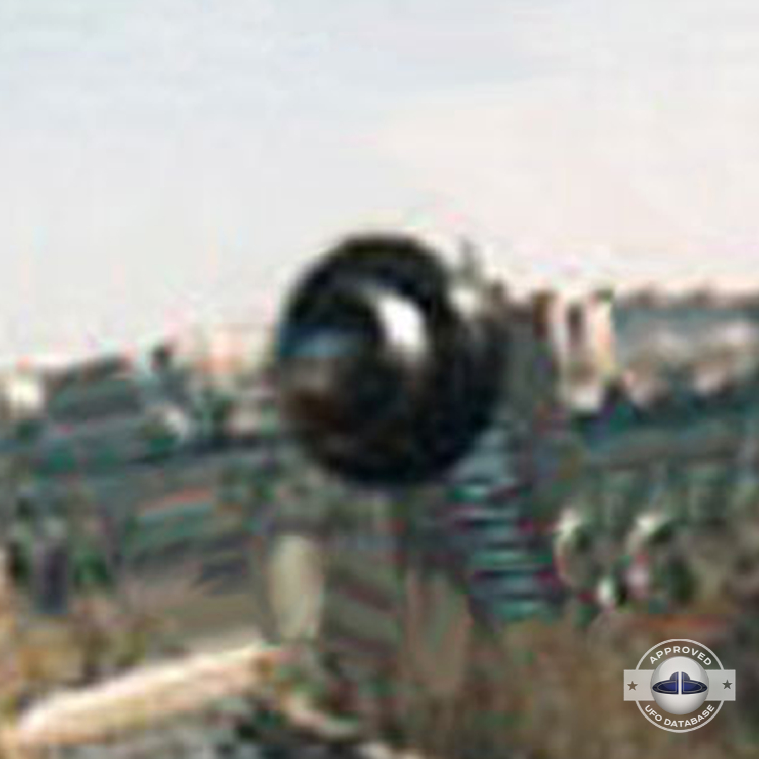 In bright day light over a water canal in the middle of Madrid UFO Picture #42-4