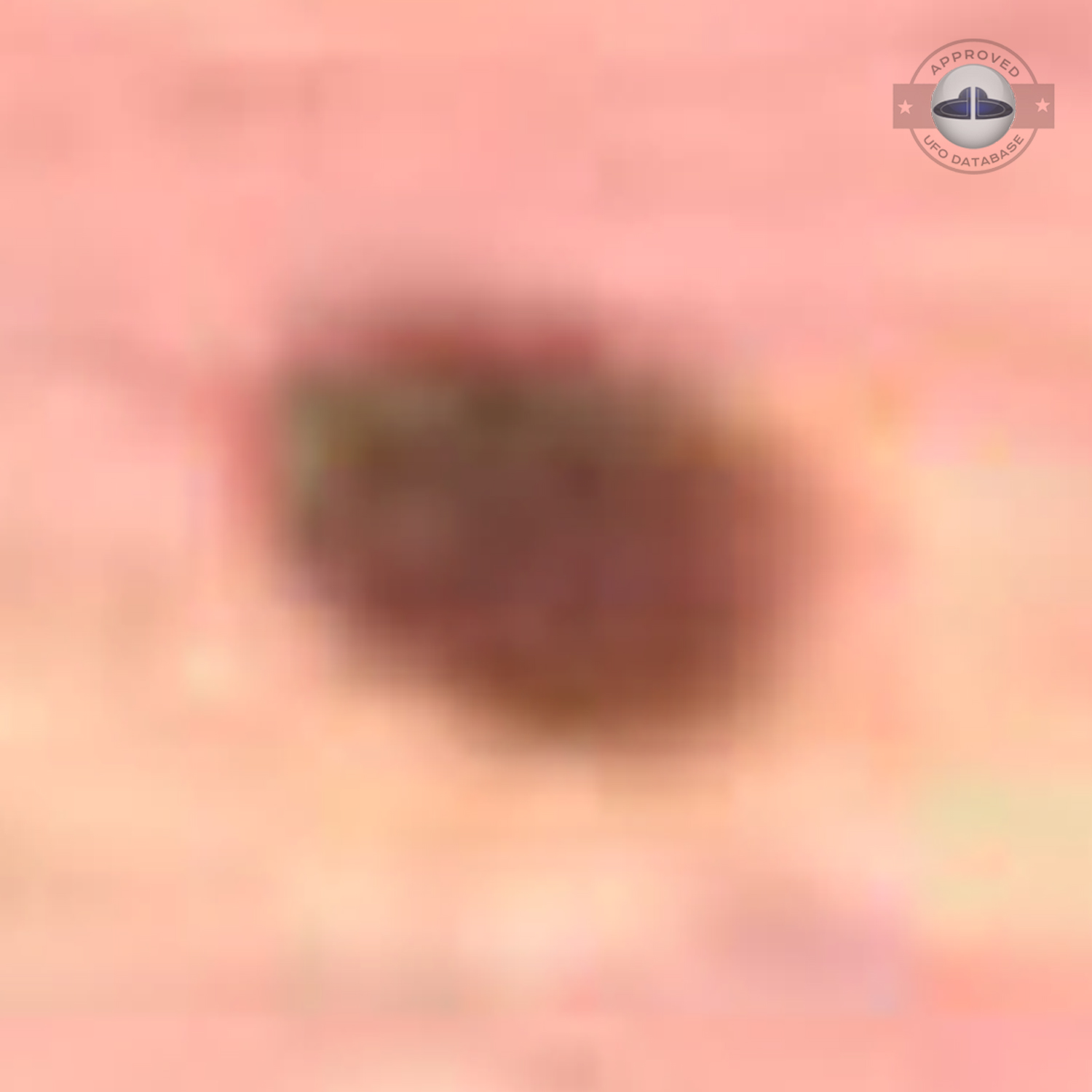 The UFO came out from a light in the cloudy sky during sunset UFO Picture #76-6