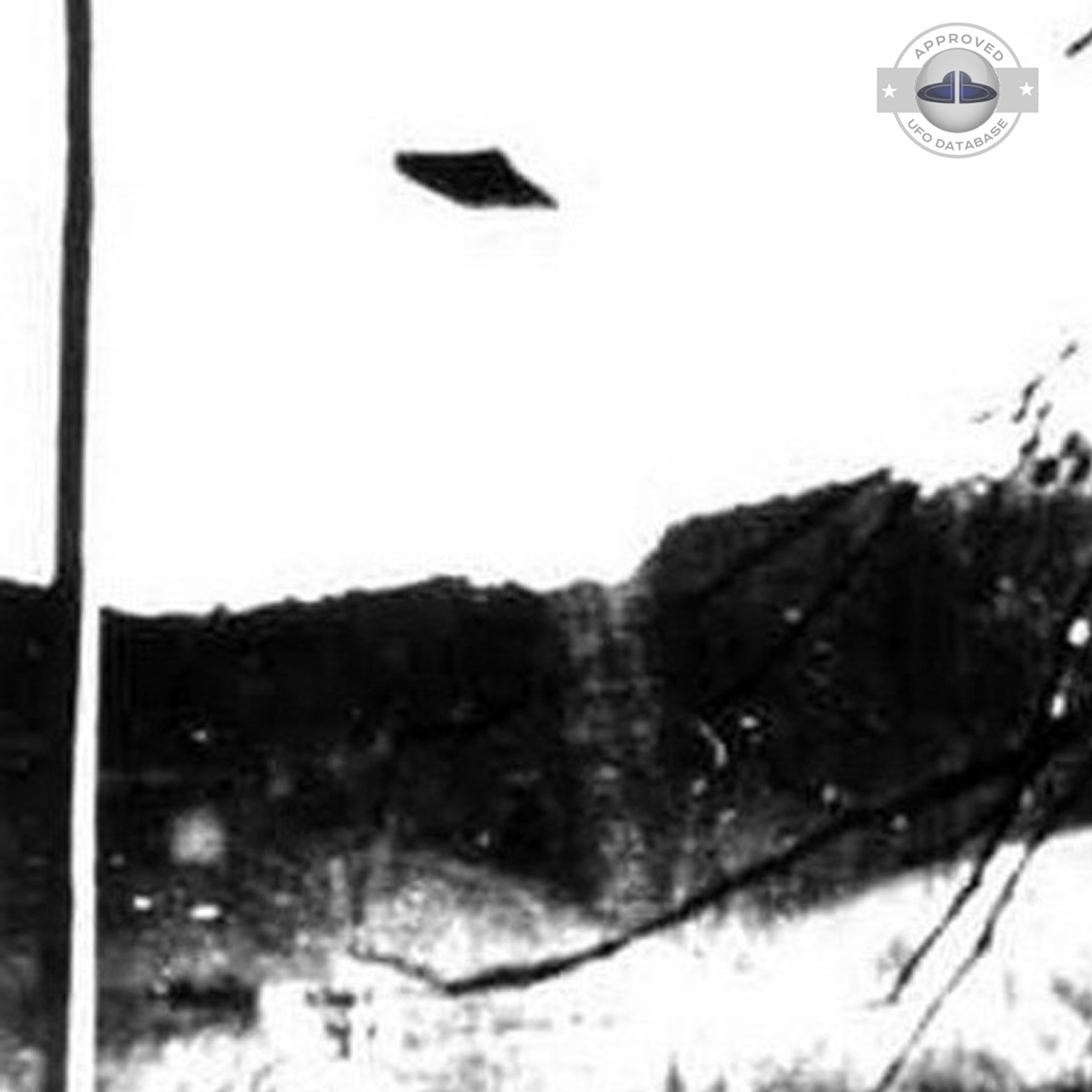 UFO seen over mountain and forest with seem to be snow on the ground UFO Picture #75-2