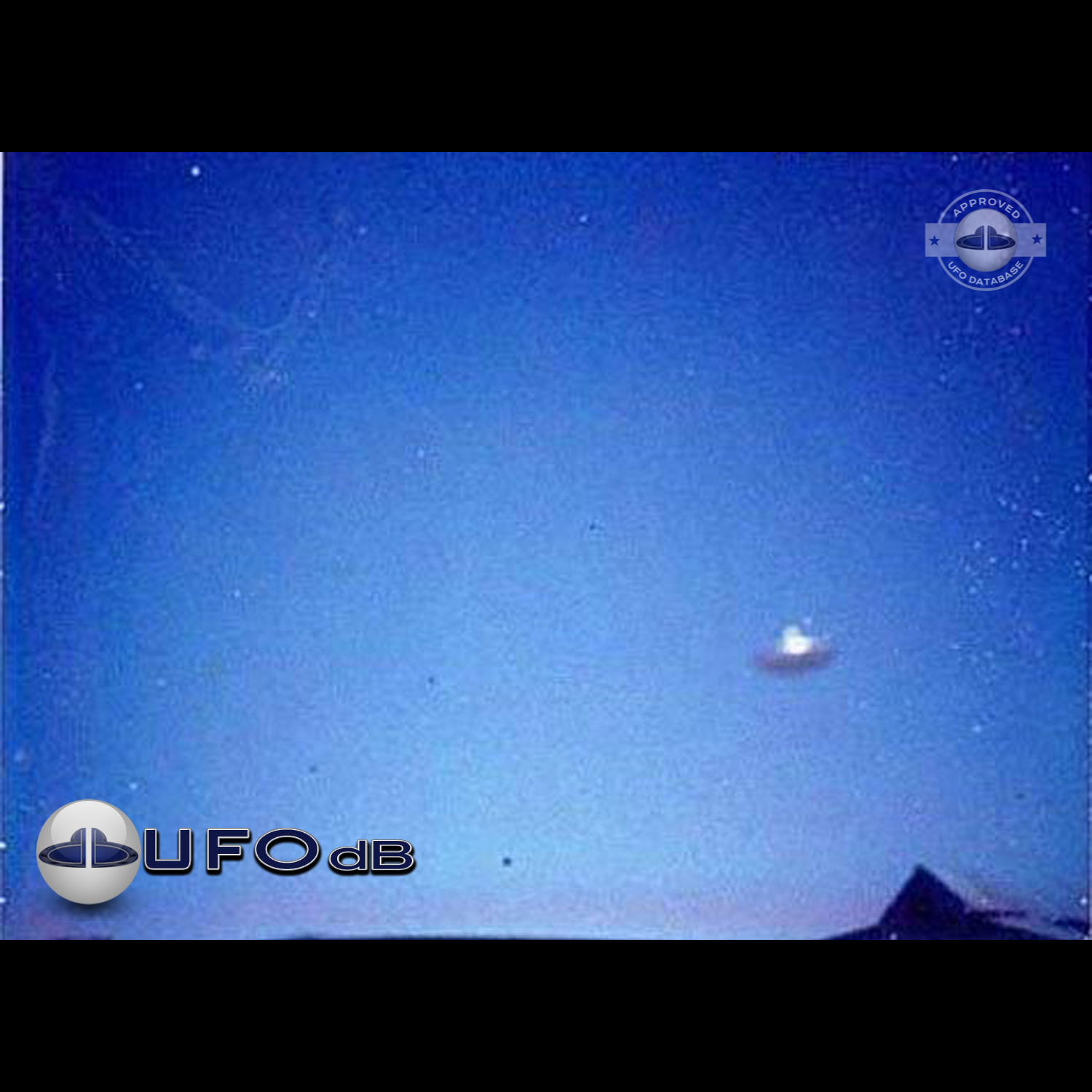 Silver metallic saucer passing over a house in the city of Alkmaar UFO Picture #73-1