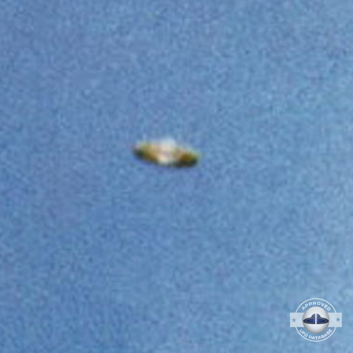 We can see a Saturn shaped UFO flying over a mountain top UFO Picture #57-4
