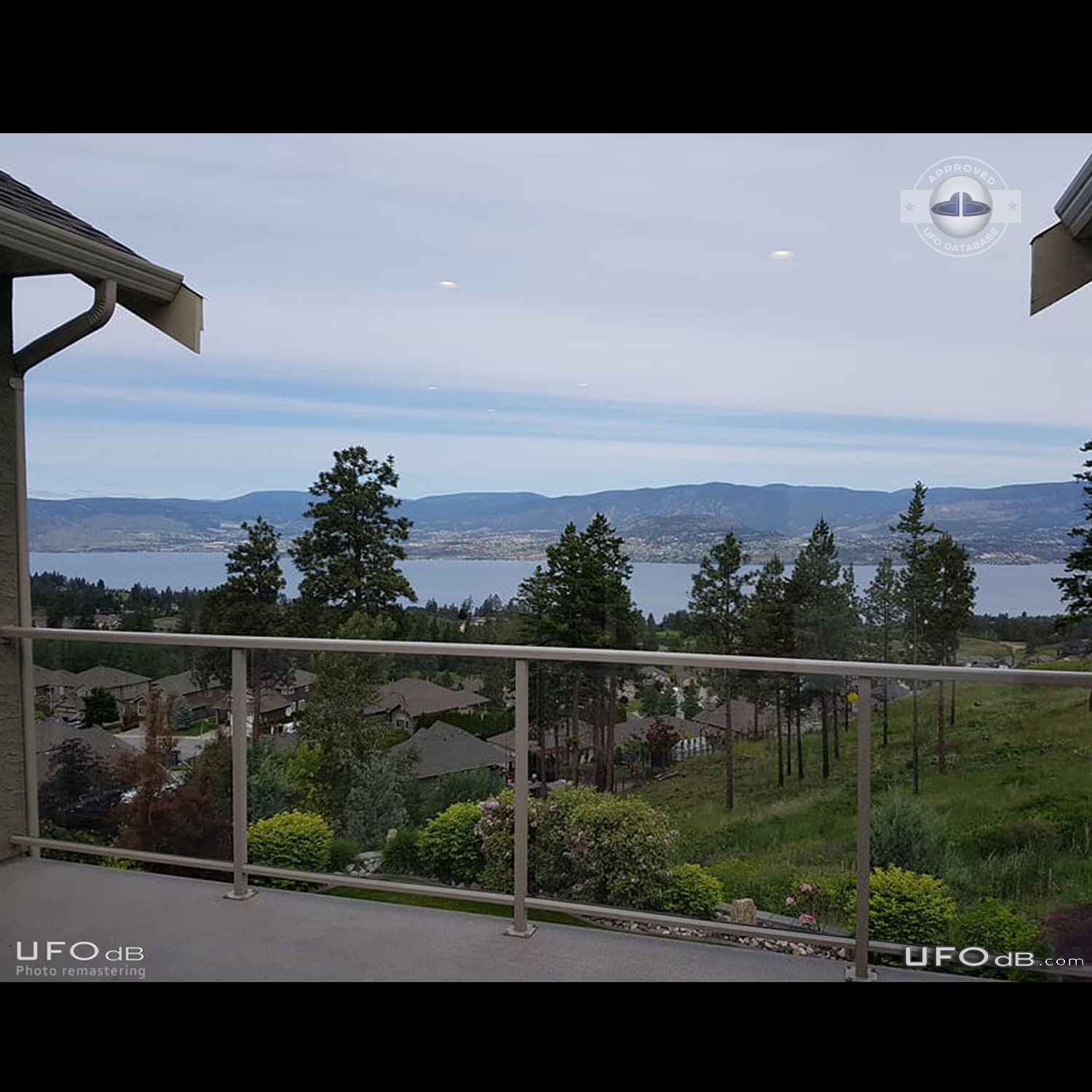White saucer UFOs in the clouds over the lake in Kelowna BC Canada 201 UFO Picture #816-1
