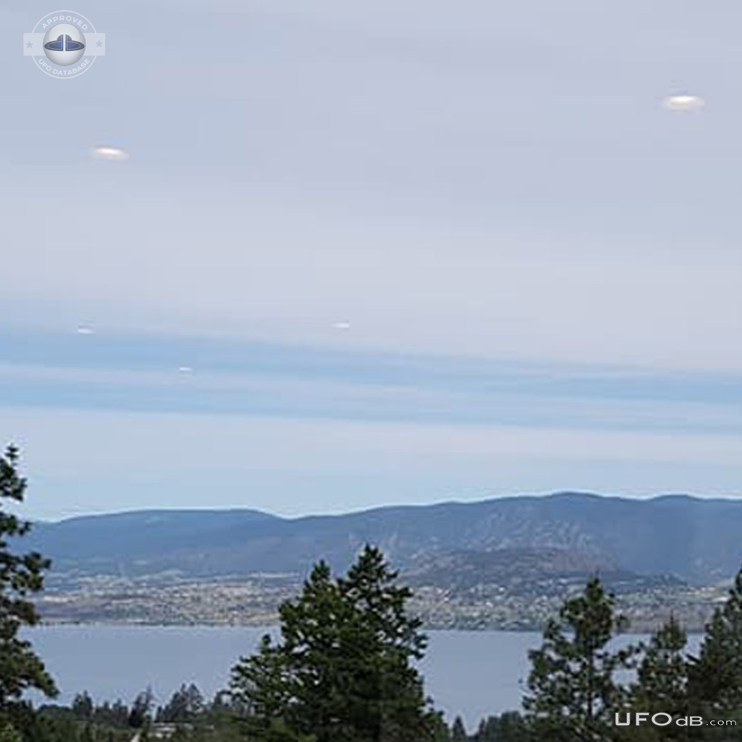 White saucer UFOs in the clouds over the lake in Kelowna BC Canada 201 UFO Picture #816-2
