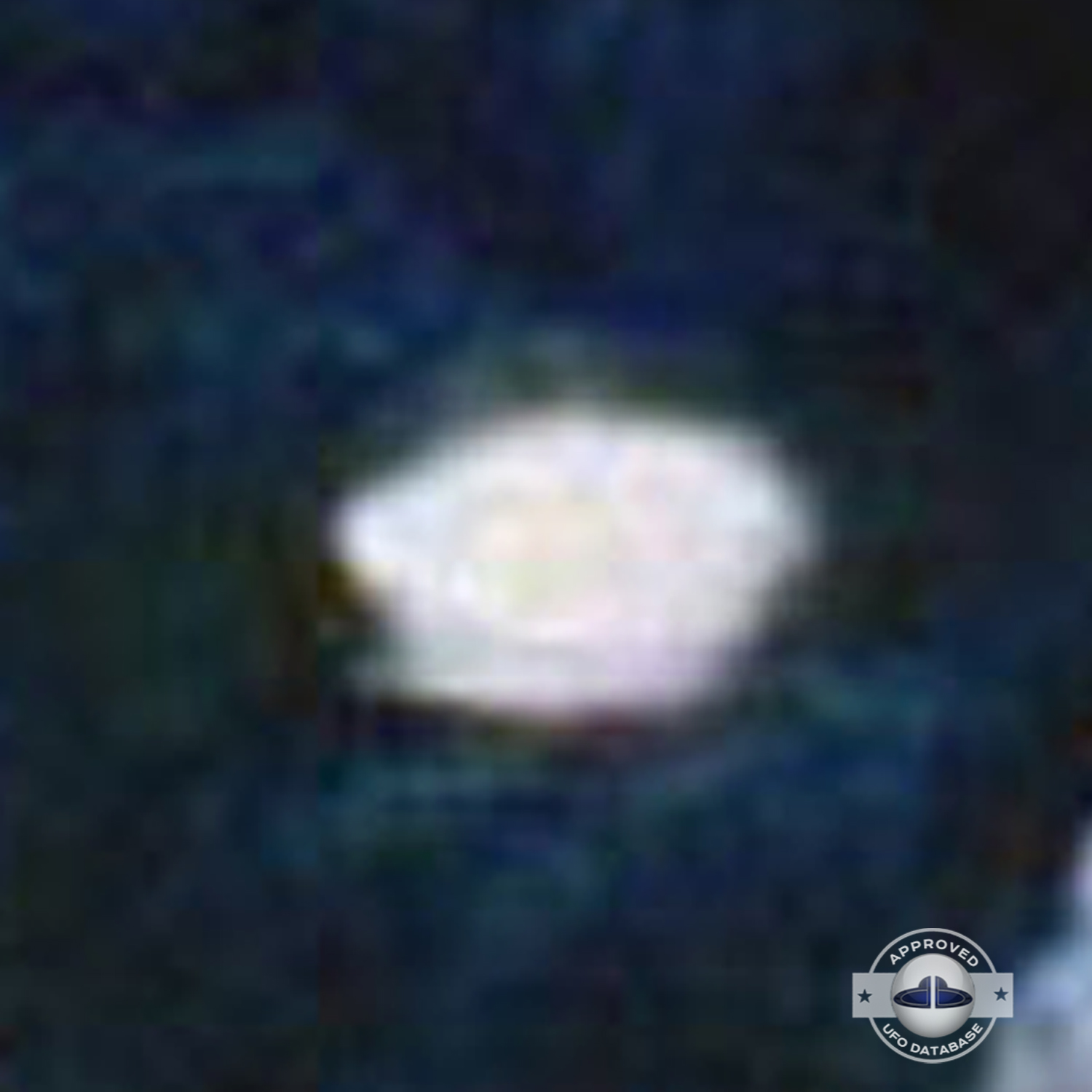 very bright disc-like object remaining stationary near a thunderhead UFO Picture #102-5