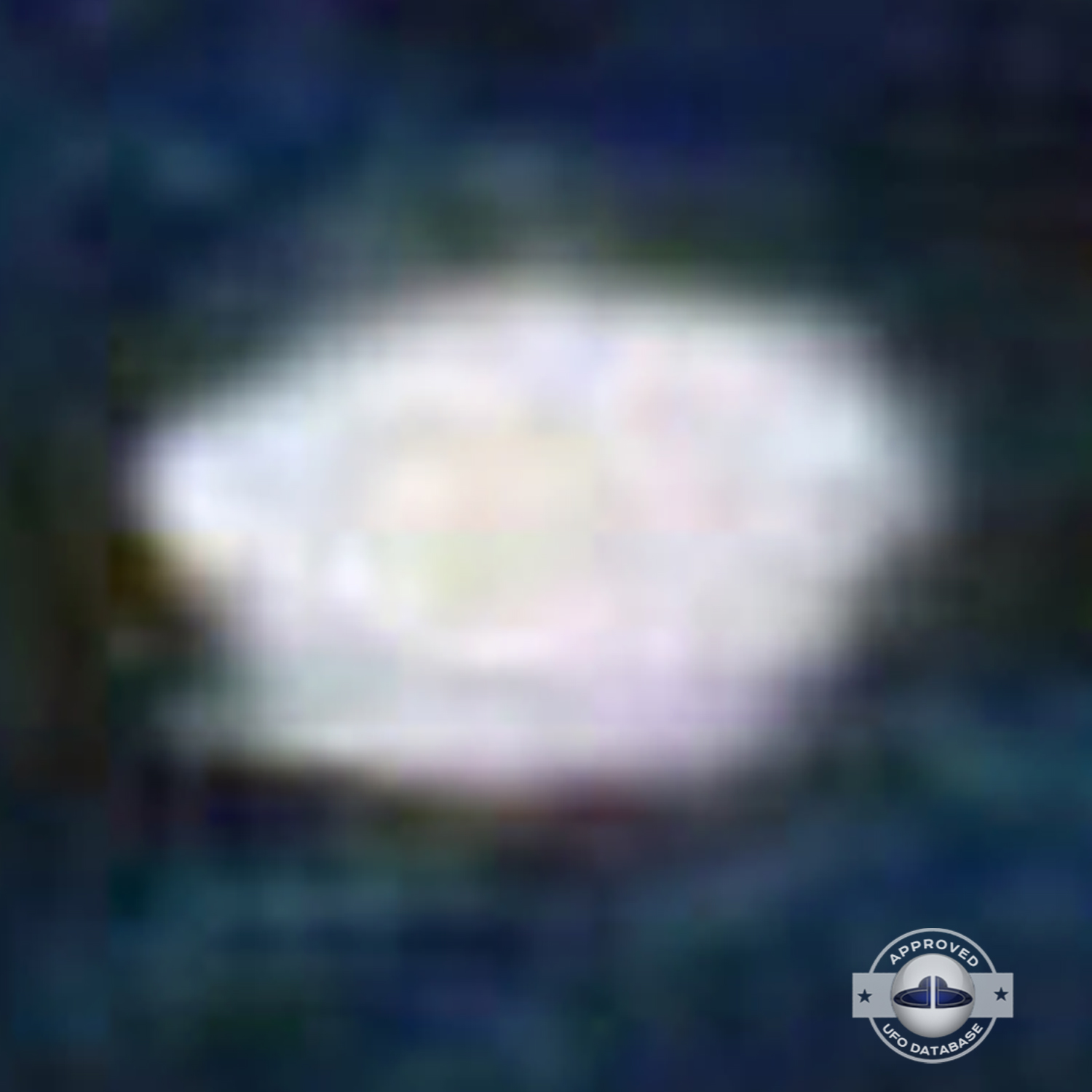 very bright disc-like object remaining stationary near a thunderhead UFO Picture #102-6