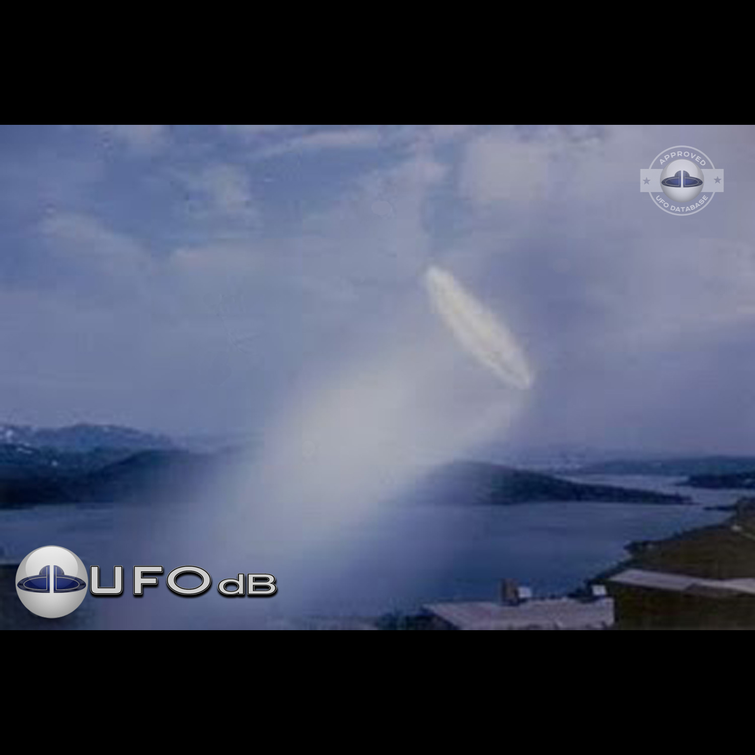 UFO almost sideways over buildings leaving a white gaseous trail 1957 UFO Picture #124-1