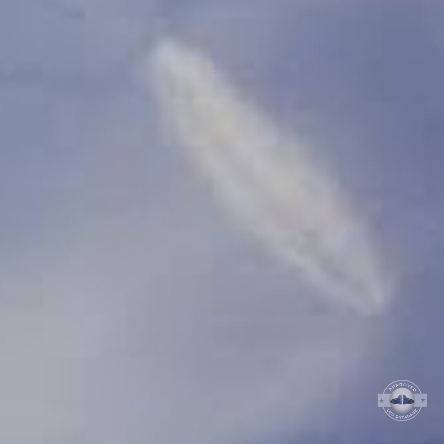 UFO almost sideways over buildings leaving a white gaseous trail 1957 UFO Picture #124-4