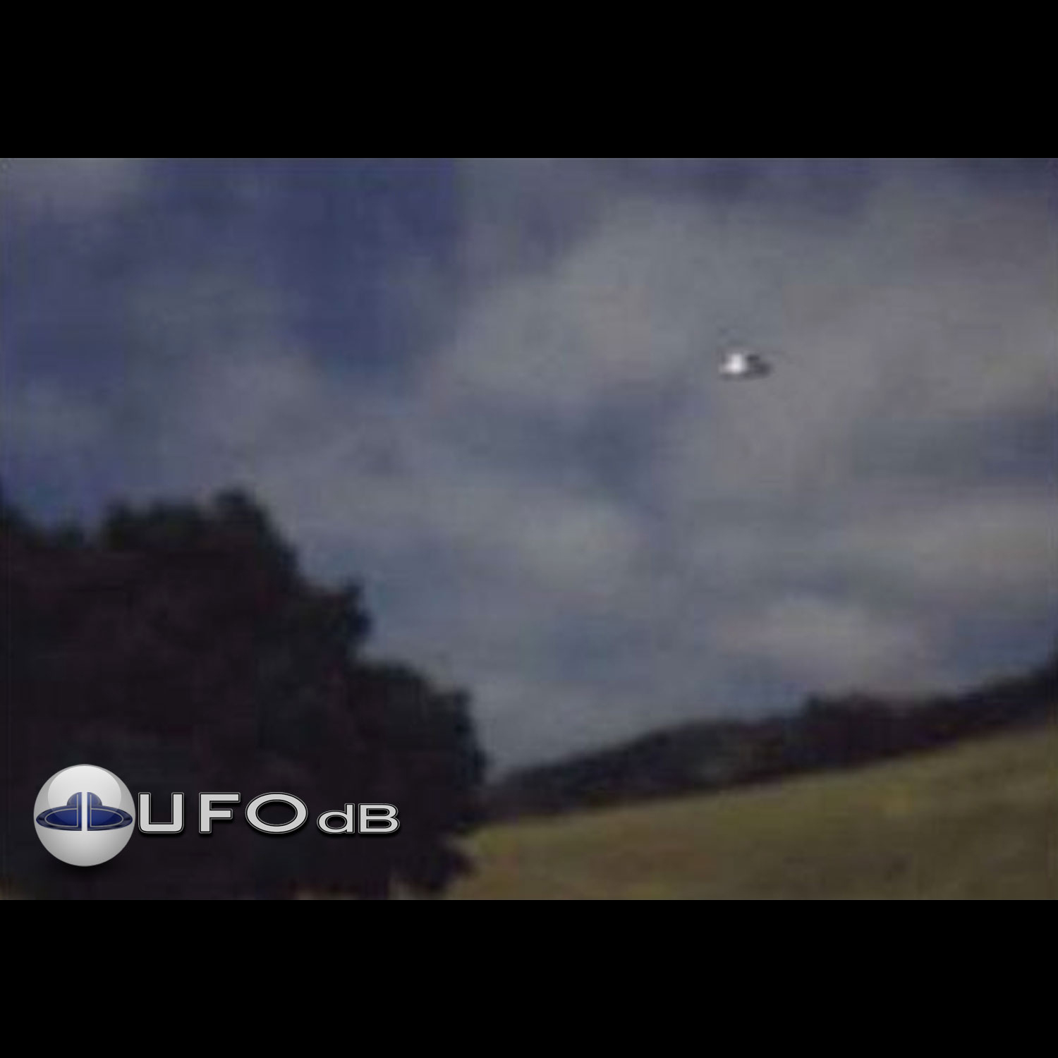 UFO over the country in Scotland during the day in a blue sky UFO Picture #15-1