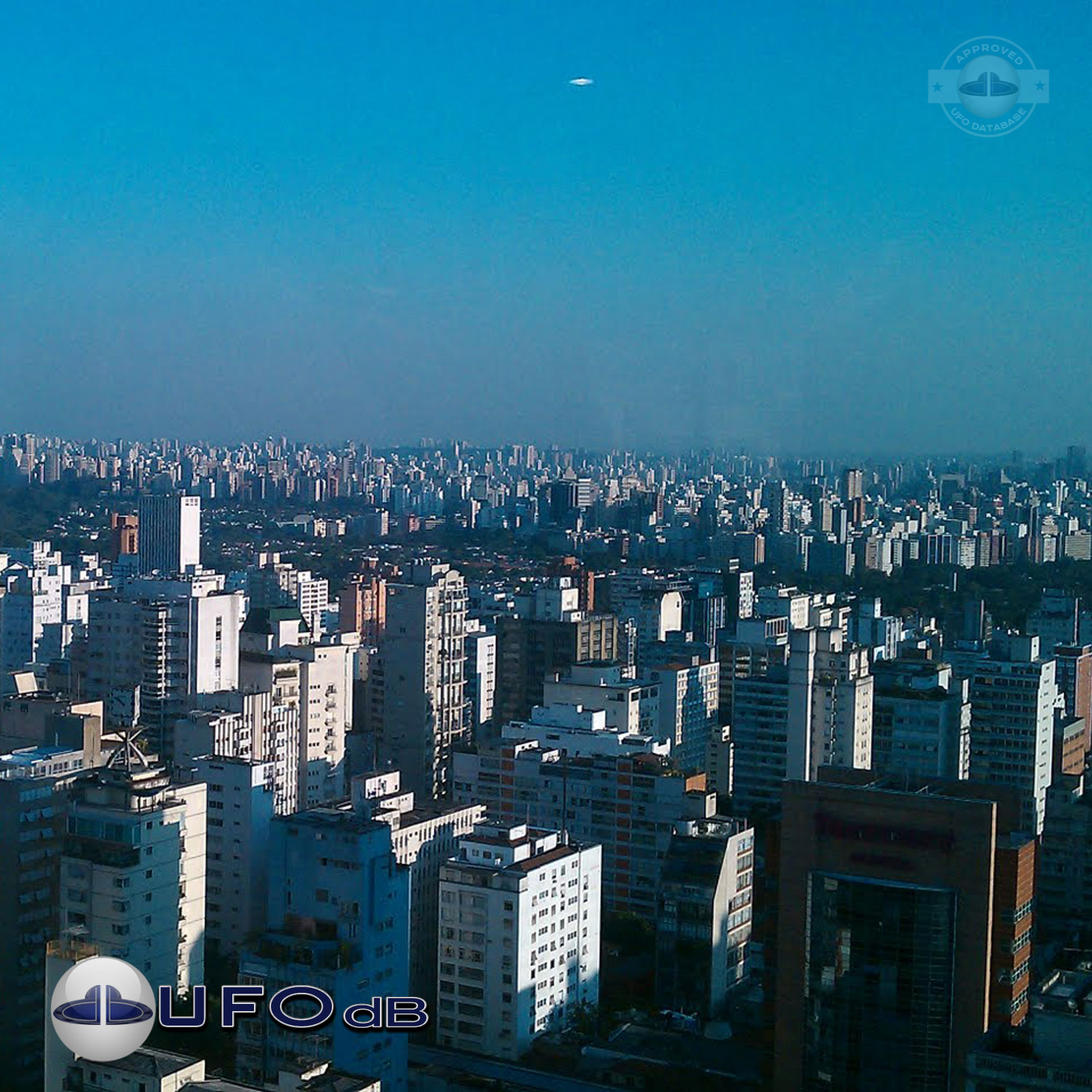 White UFO passing in cloudless turquoise sky over Sao Paulo Brazil UFO Picture #204-1