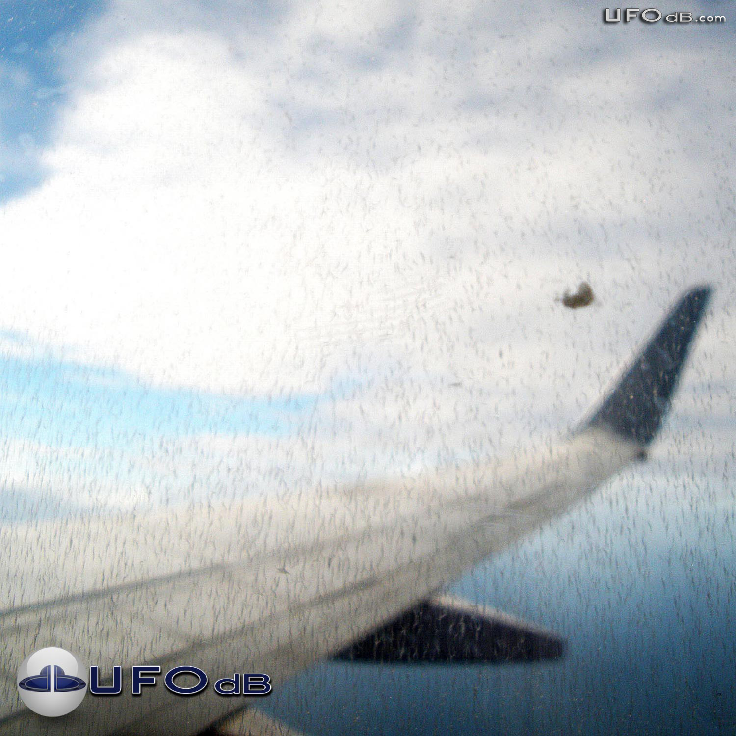 Cloaking UFO near wing of flying Airplane in Australia | January 2011 UFO Picture #243-1