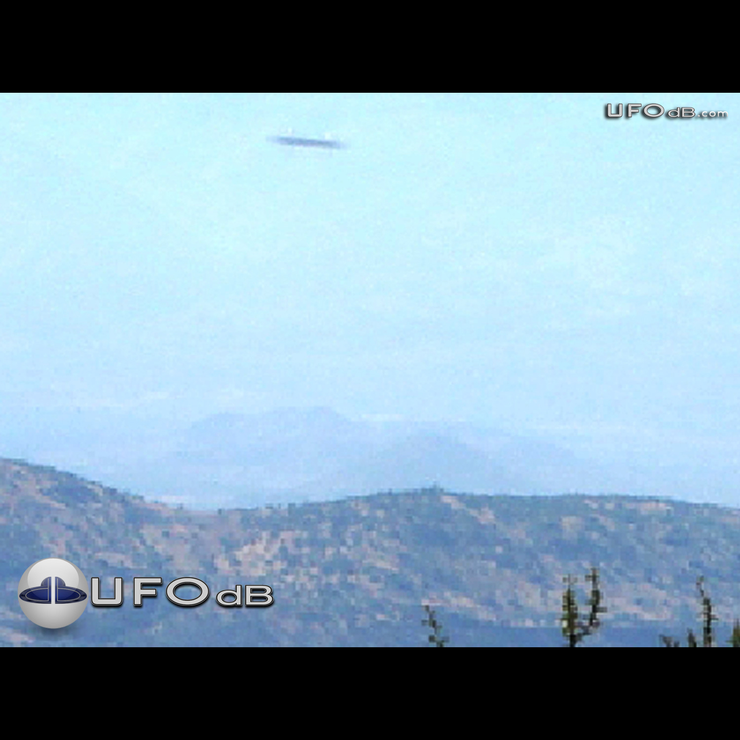 Colombia Saucer flying over the hills caught on picture | March 3 2003 UFO Picture #322-1