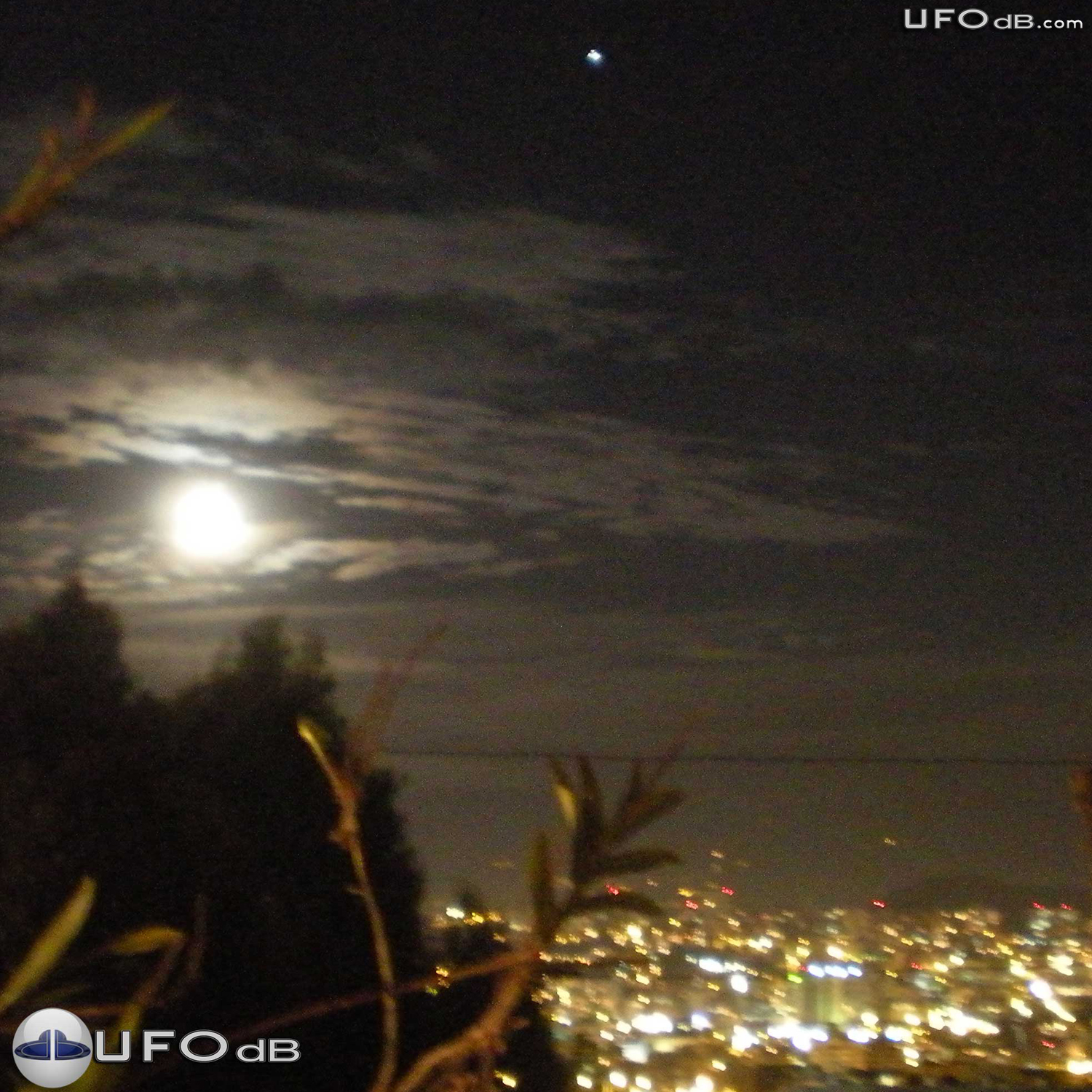 Moon picture captures bright white glowing UFO over a city in Ecuador UFO Picture #352-1