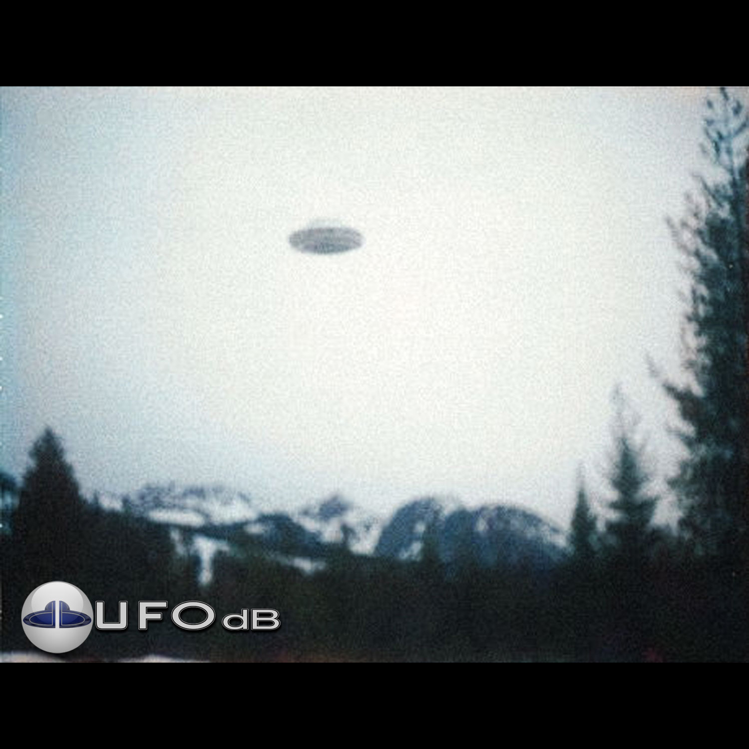 UFO picture showing UFO over snowy mountains during the day UFO Picture #36-1