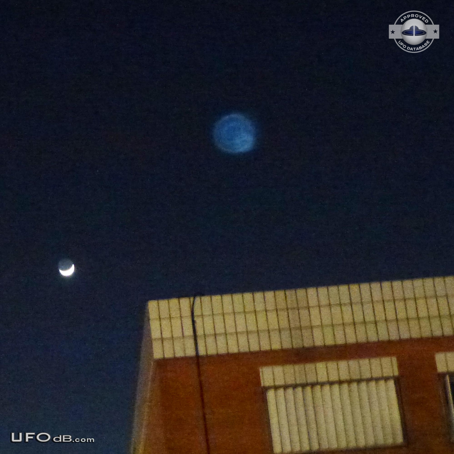 Blue round UFO appears on photo over buildings - Catalonia, Spain 2012 UFO Picture #407-1