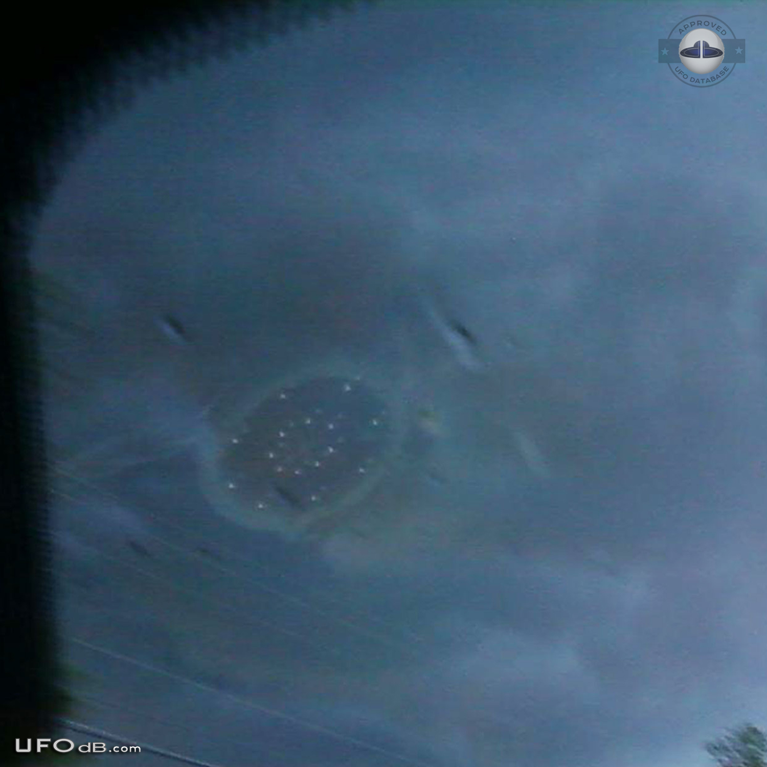 Large saucer ufo appears through dark stormy clouds - Malone, New York UFO Picture #414-2