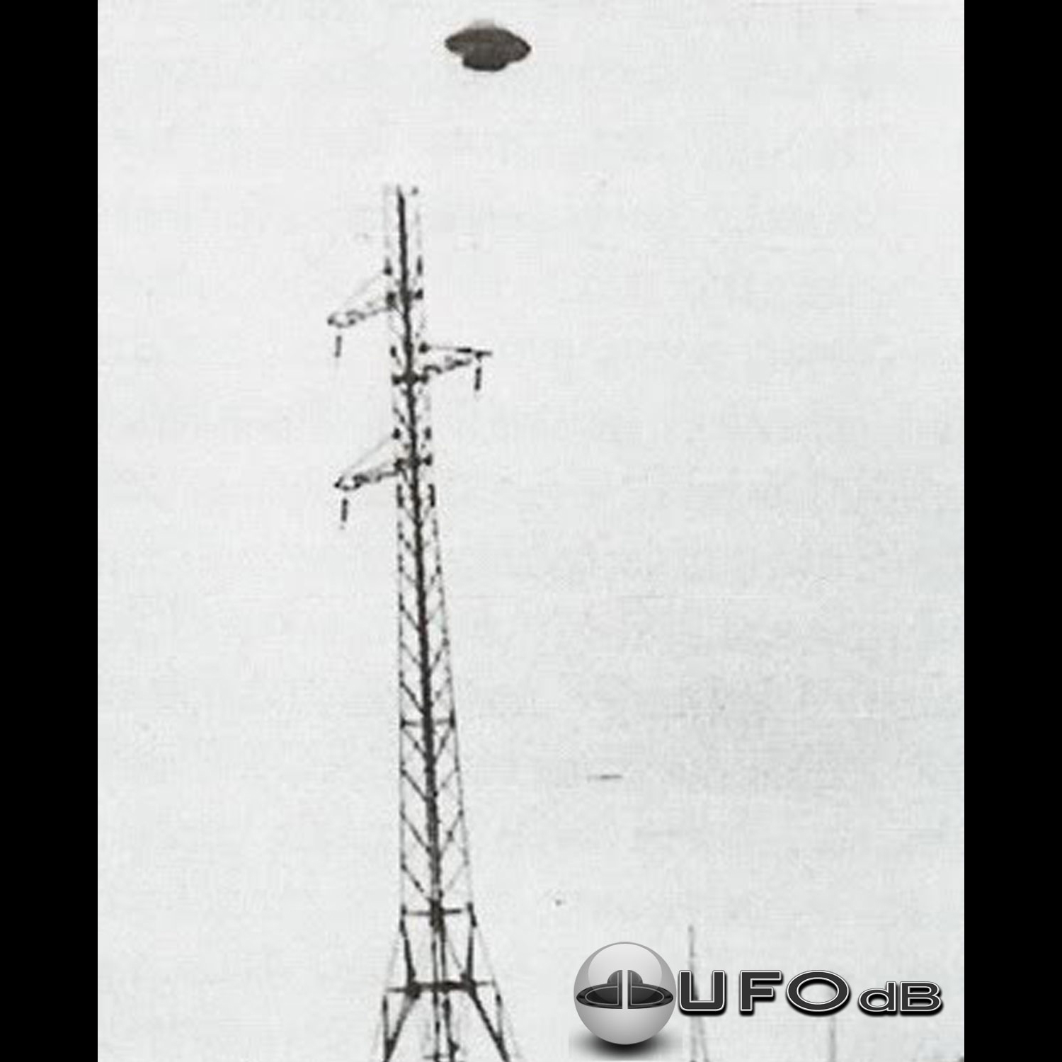 UFO muffin shape flying saucer standing over electrical stucture UFO Picture #46-1