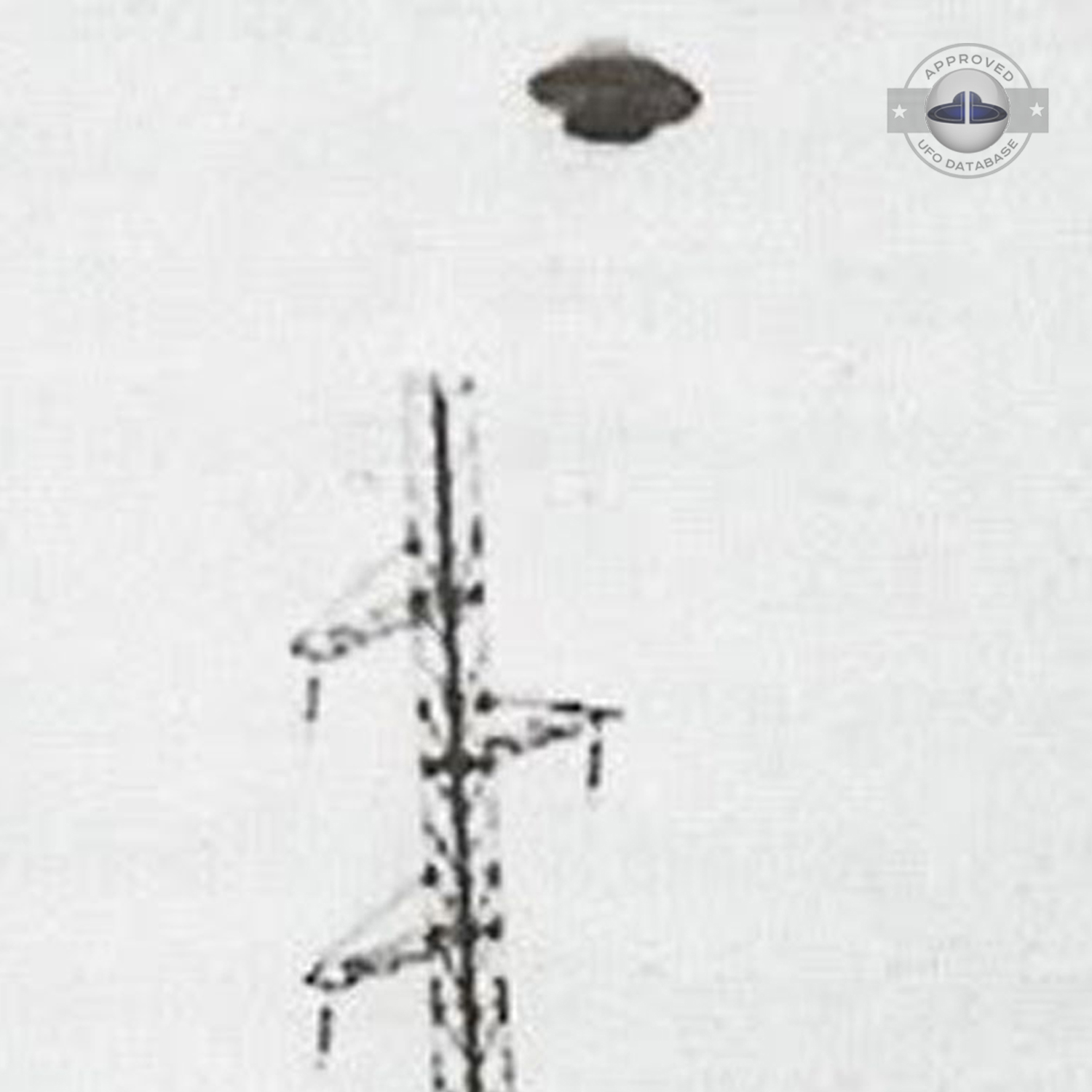 UFO muffin shape flying saucer standing over electrical stucture UFO Picture #46-3
