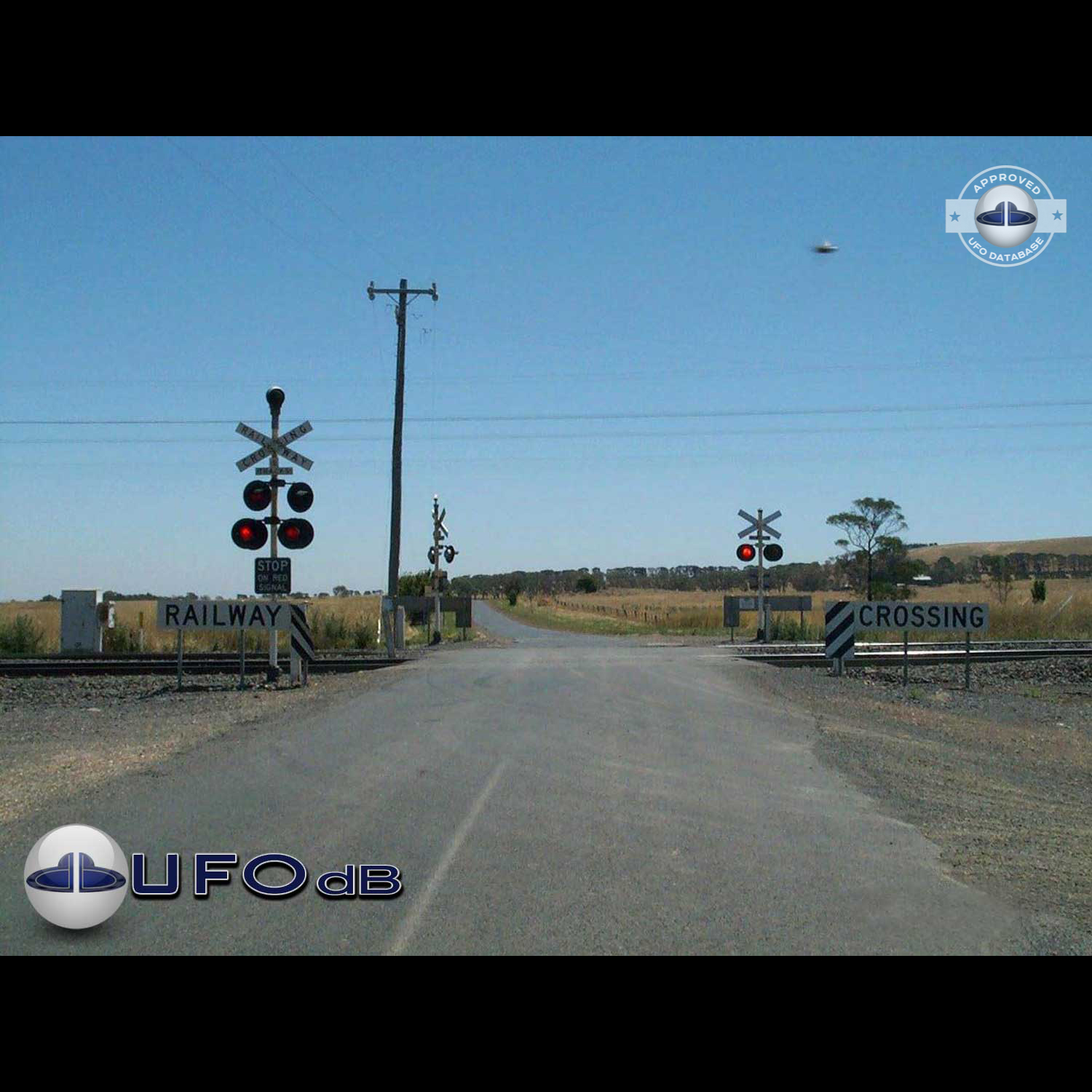 UFO picture showing UFO flying near railroad crossing UFO Picture #47-1