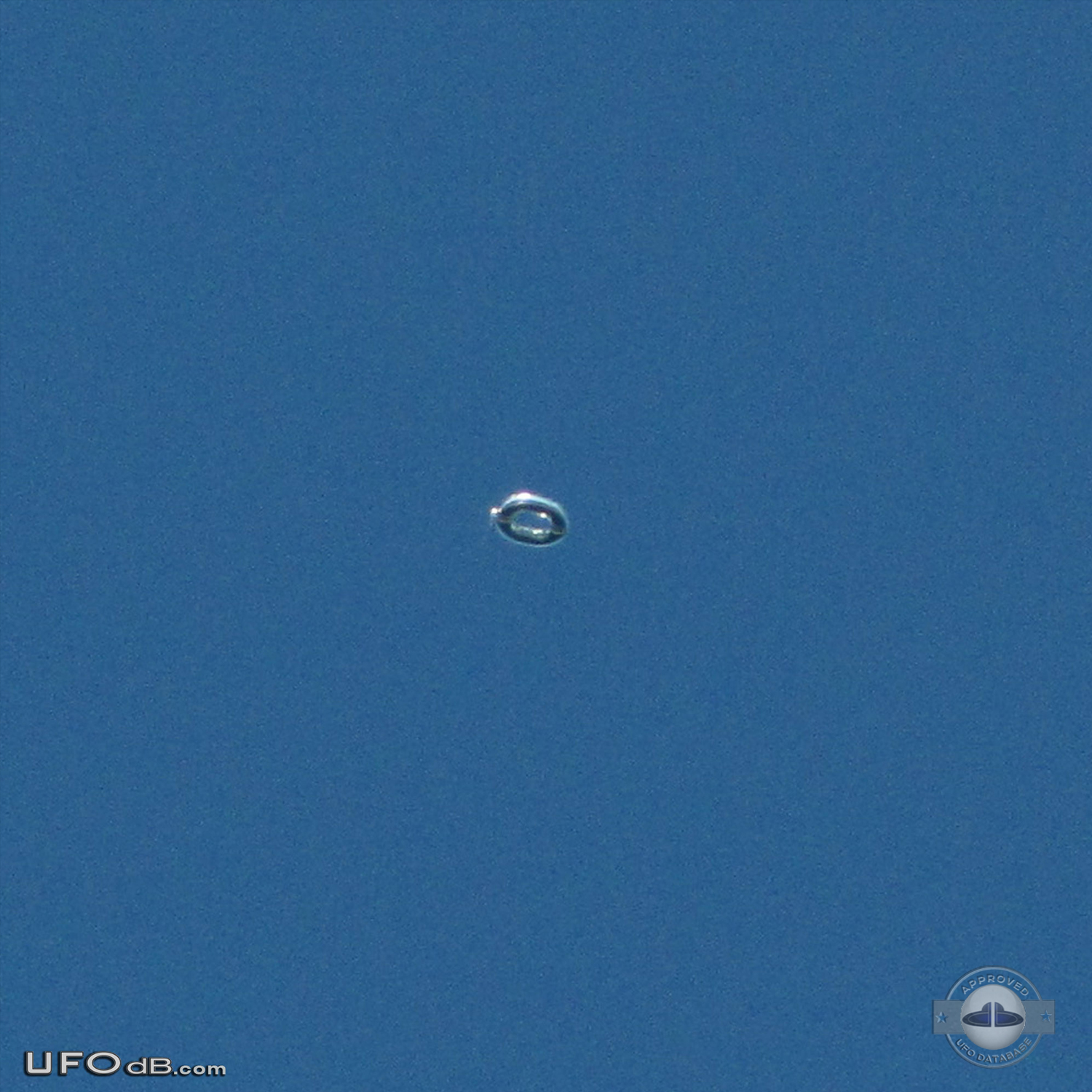 Donut shaped UFO with glowing silver material over Scituate Ma US 2012 UFO Picture #481-1
