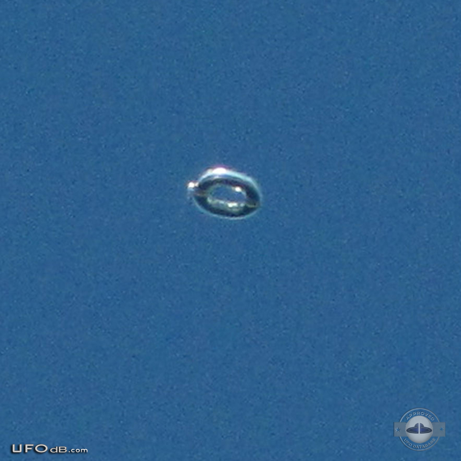 Donut shaped UFO with glowing silver material over Scituate Ma US 2012 UFO Picture #481-2