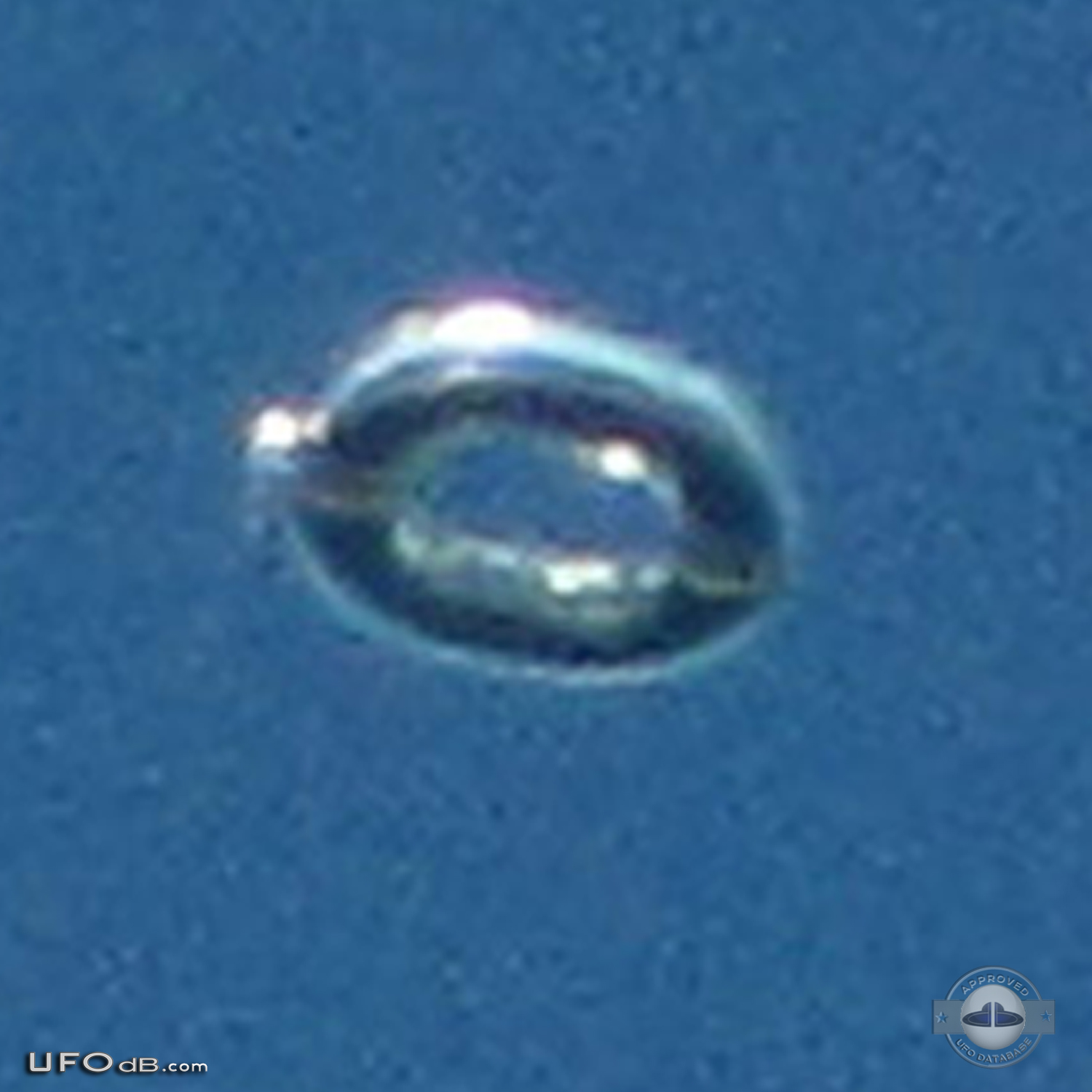 Donut shaped UFO with glowing silver material over Scituate Ma US 2012 UFO Picture #481-3