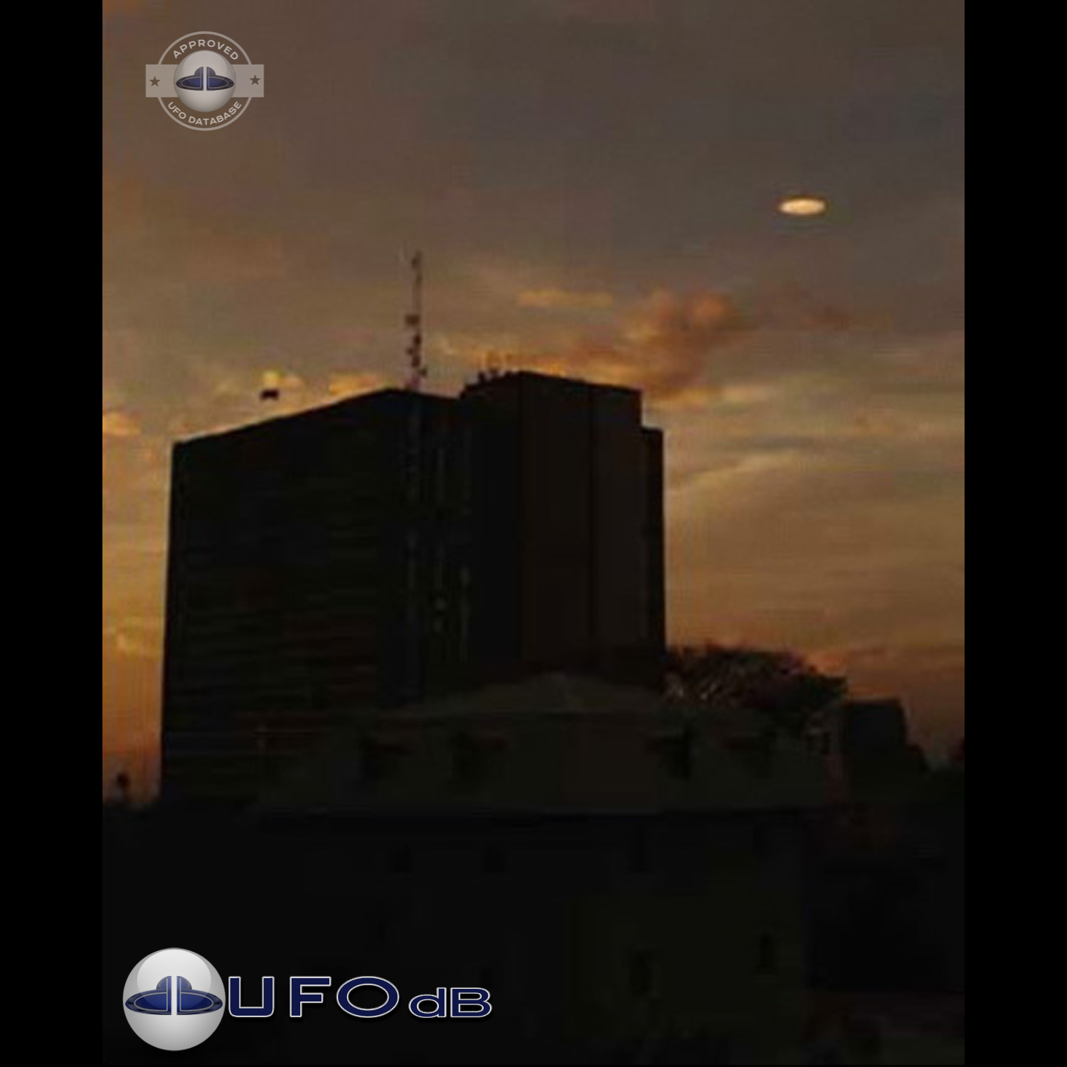 UFO picture showing a bright flat round disc passing near a building UFO Picture #54-1