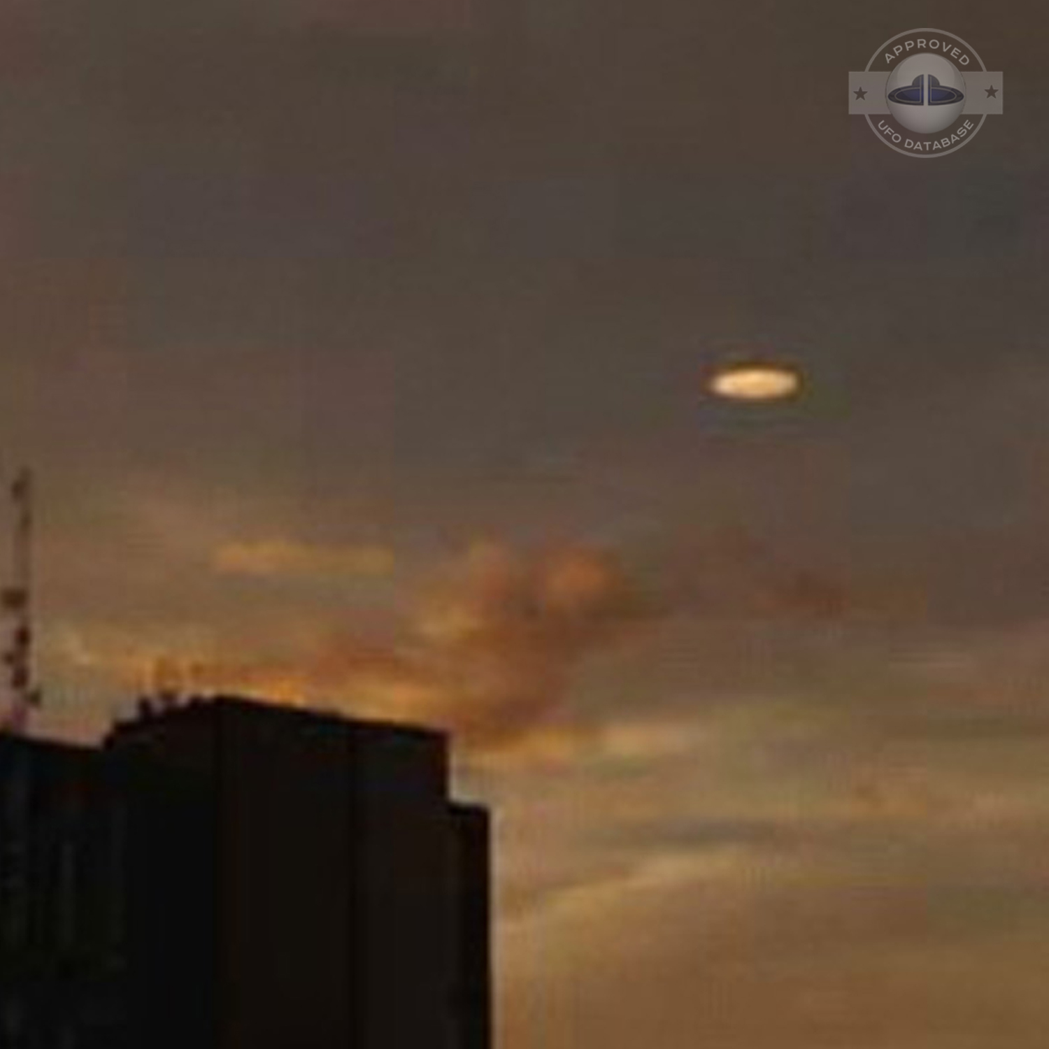 UFO picture showing a bright flat round disc passing near a building UFO Picture #54-3