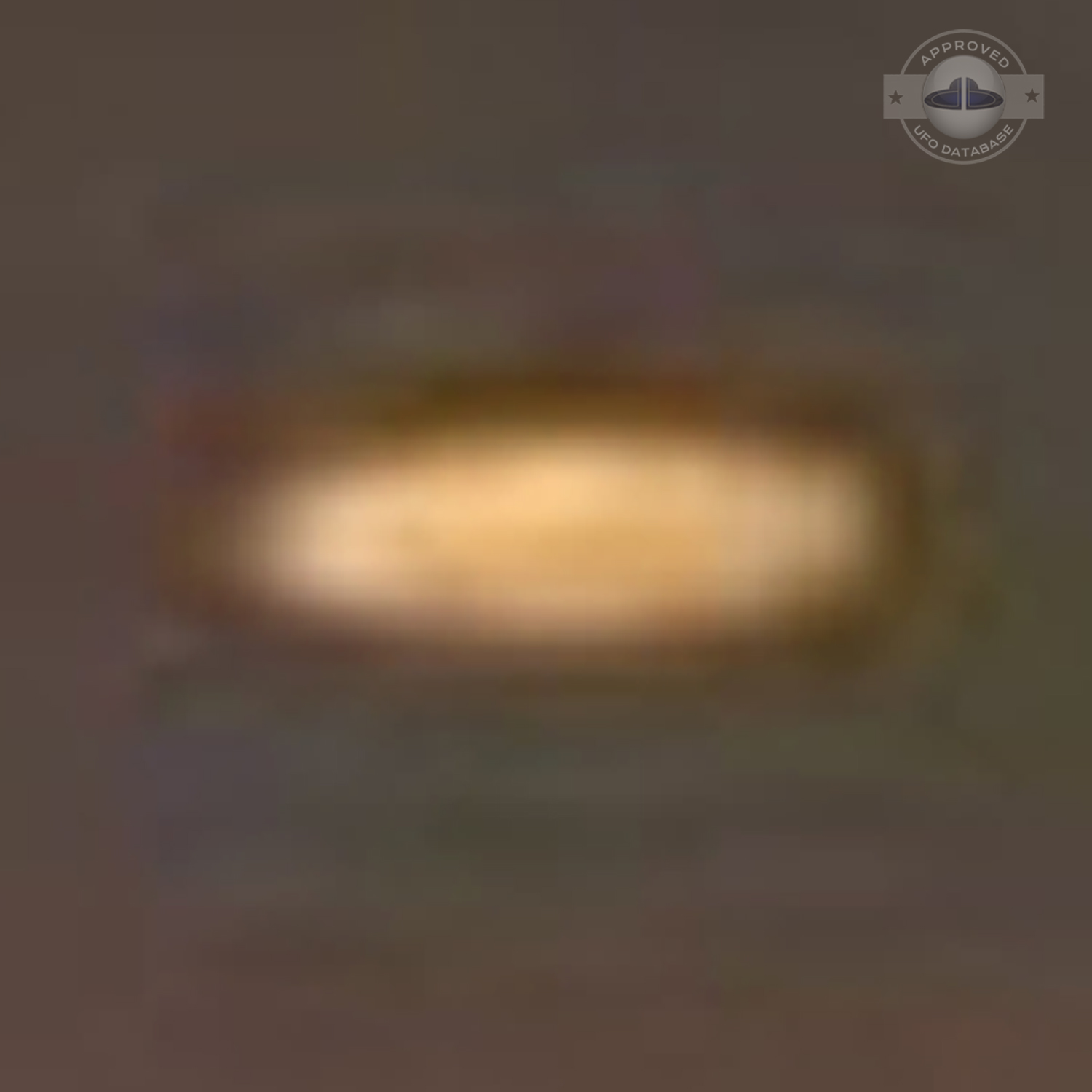 UFO picture showing a bright flat round disc passing near a building UFO Picture #54-6