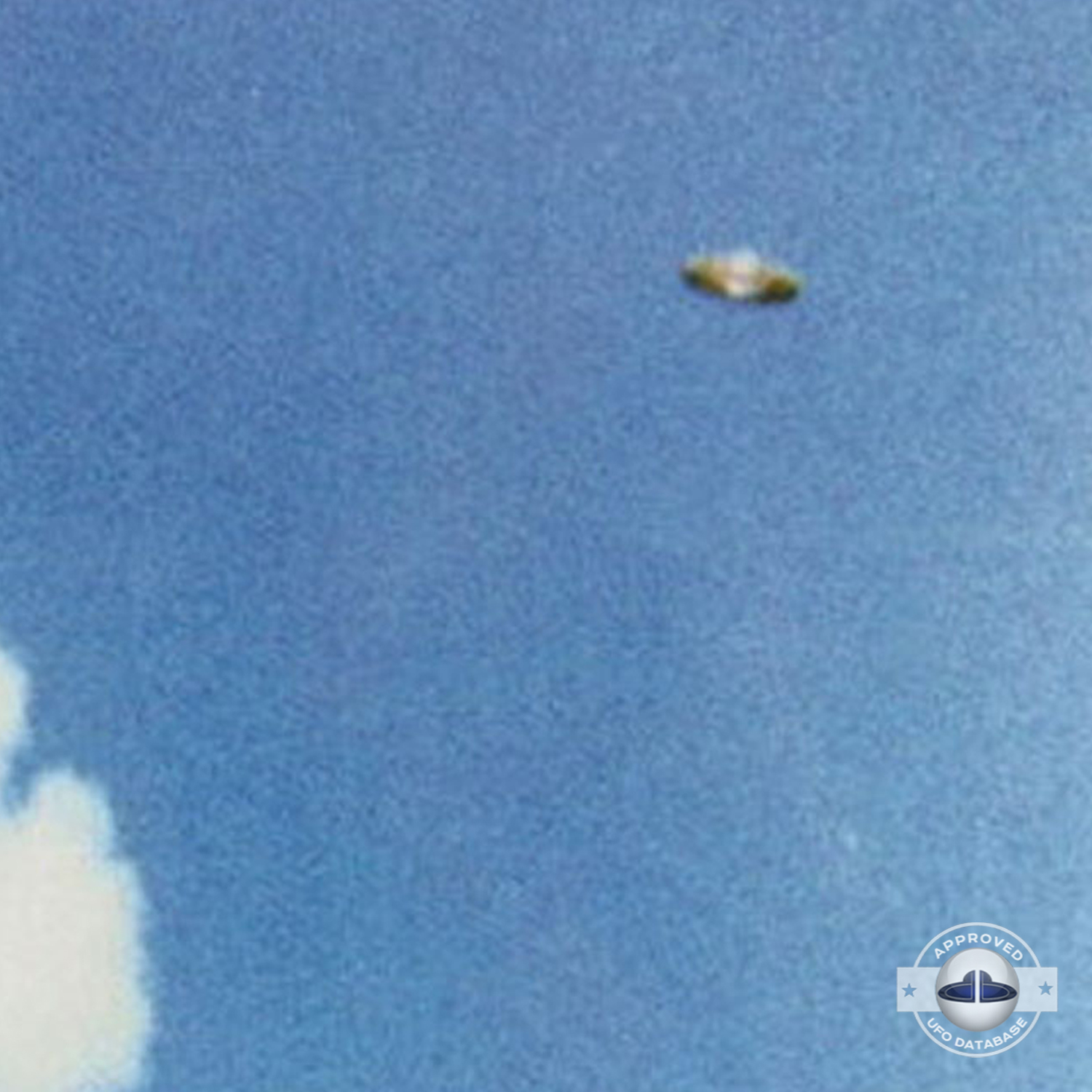We can see a Saturn shaped UFO flying over a mountain top UFO Picture #57-3