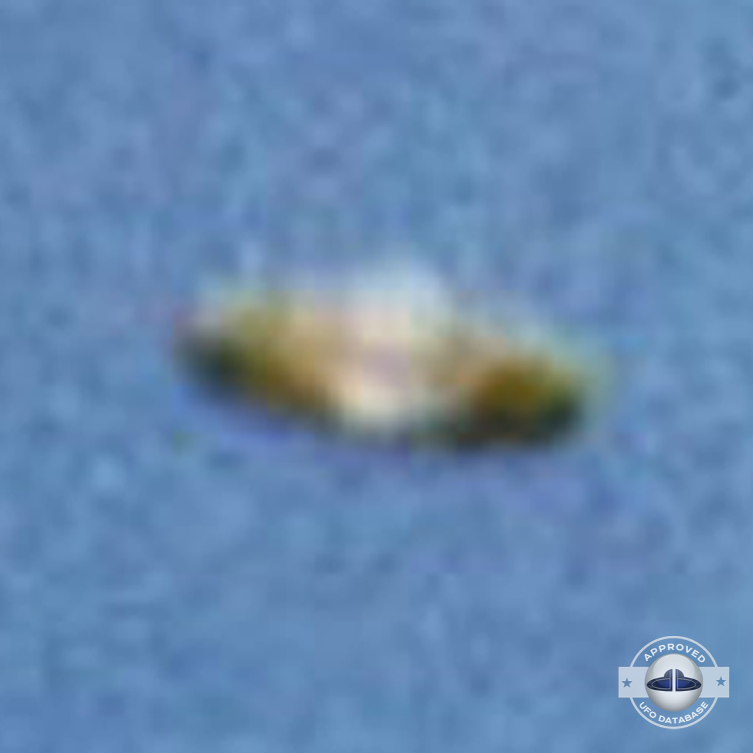 We can see a Saturn shaped UFO flying over a mountain top UFO Picture #57-5