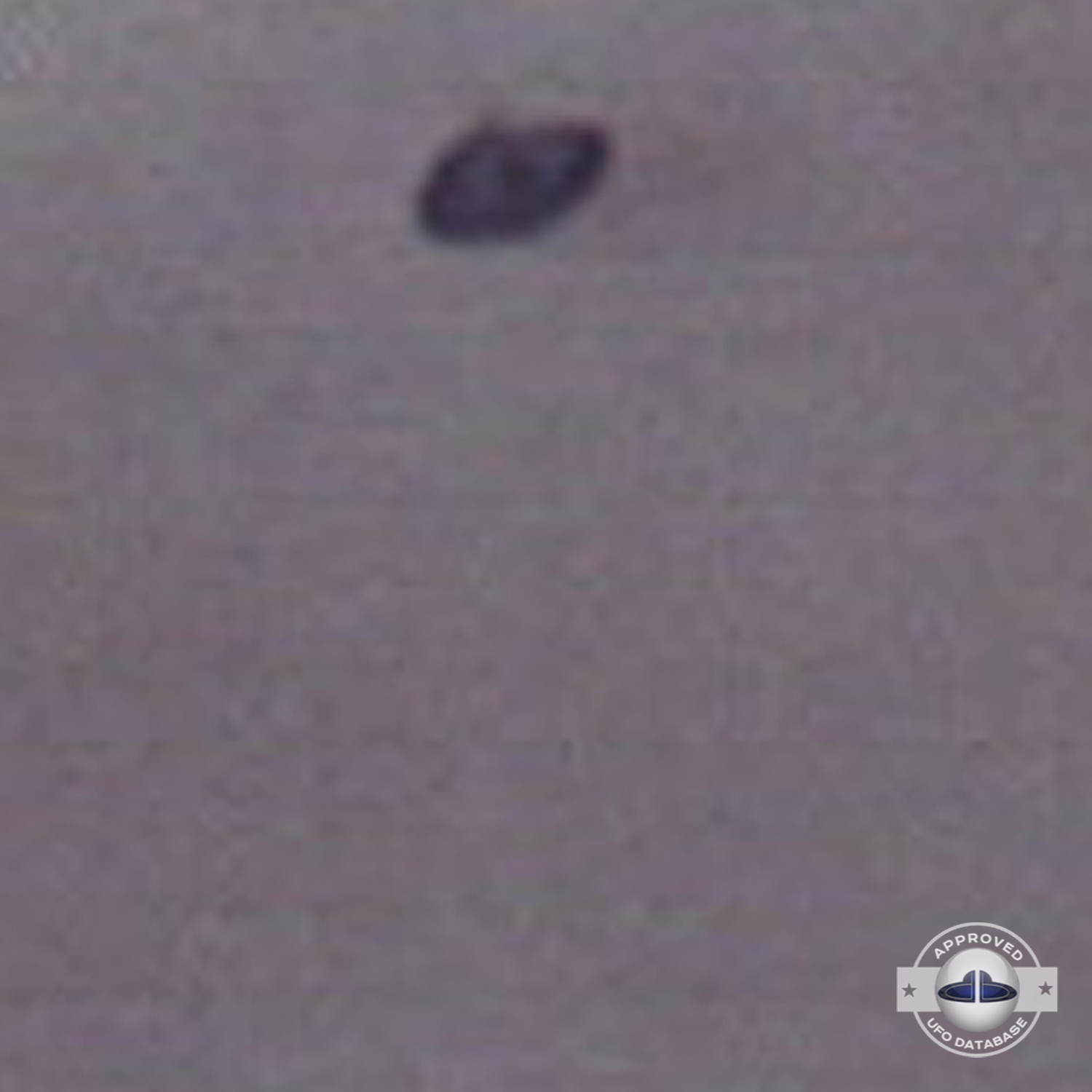 Unidentified flying object is flying over a building with antennas UFO Picture #59-3