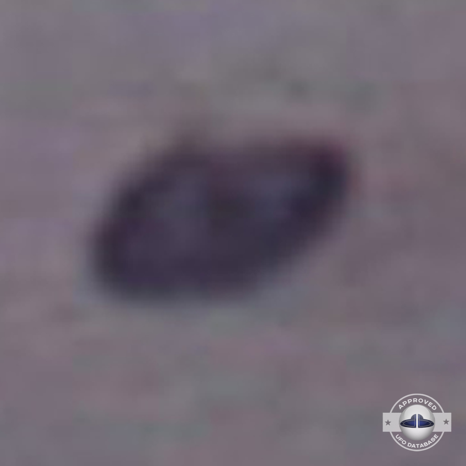 Unidentified flying object is flying over a building with antennas UFO Picture #59-4