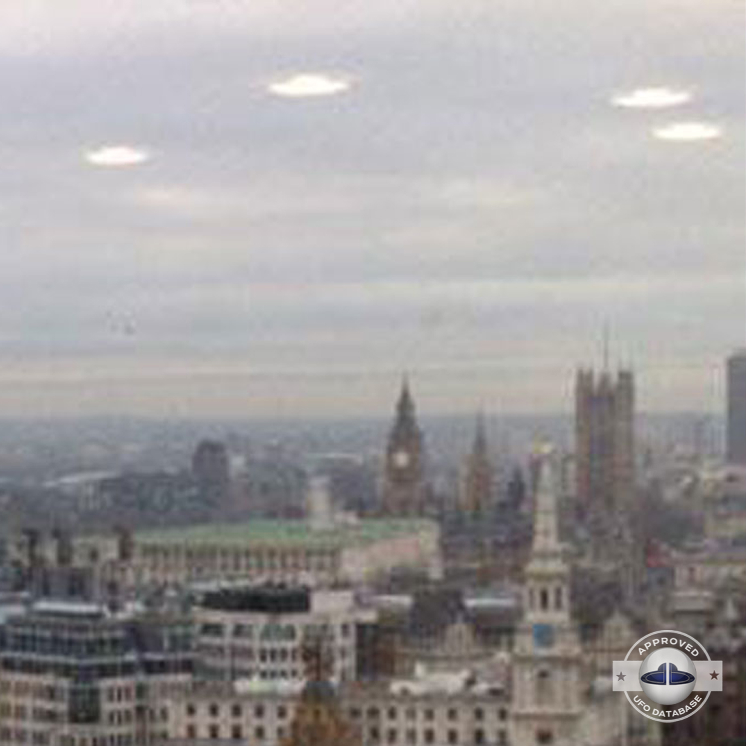 UFO picture we can see 4 white rounds coming out of the grey clouds UFO Picture #60-3