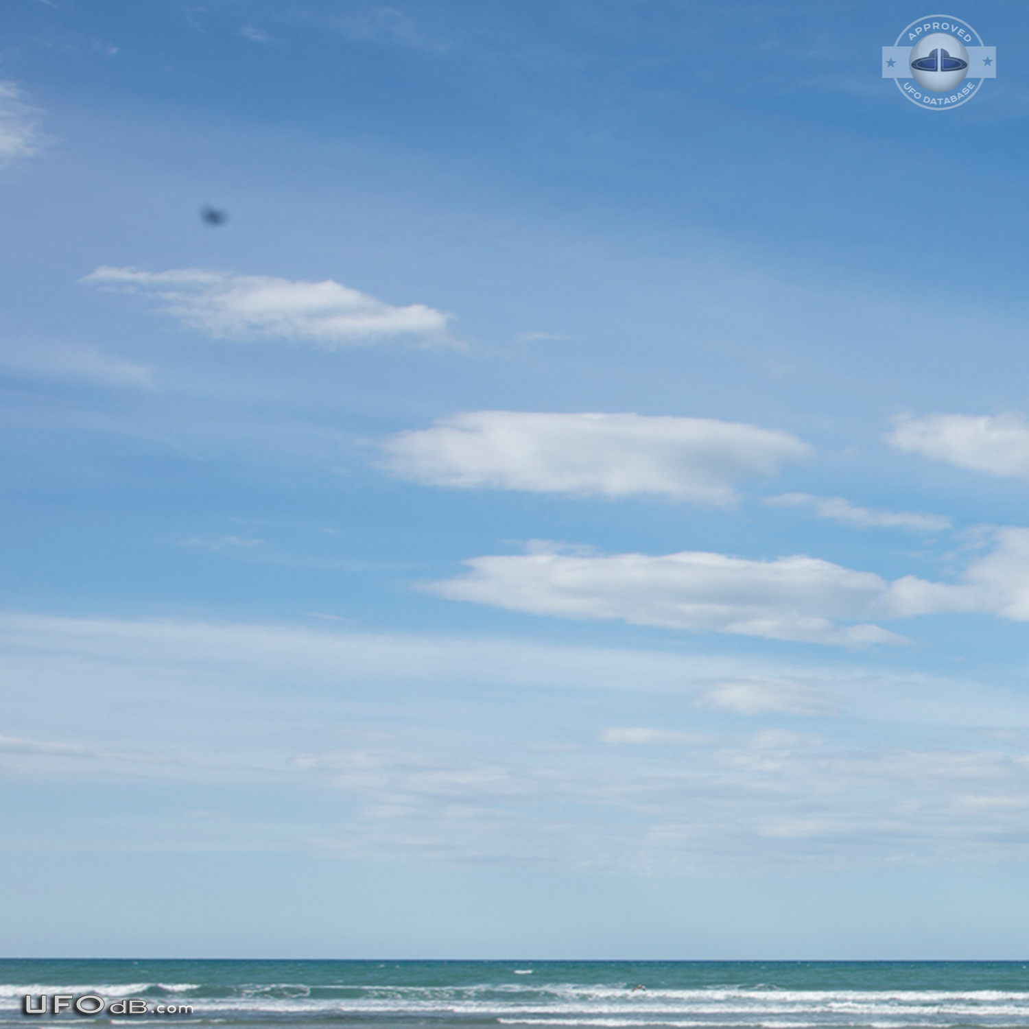 Stationary dark UFO over ohope beach near Whakatane NZ 2015 UFO Picture #600-3