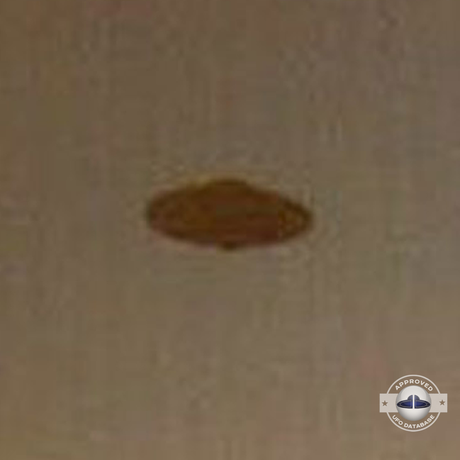 The UFO has a Saturn shape and can be seen at nightfall over a house UFO Picture #65-4
