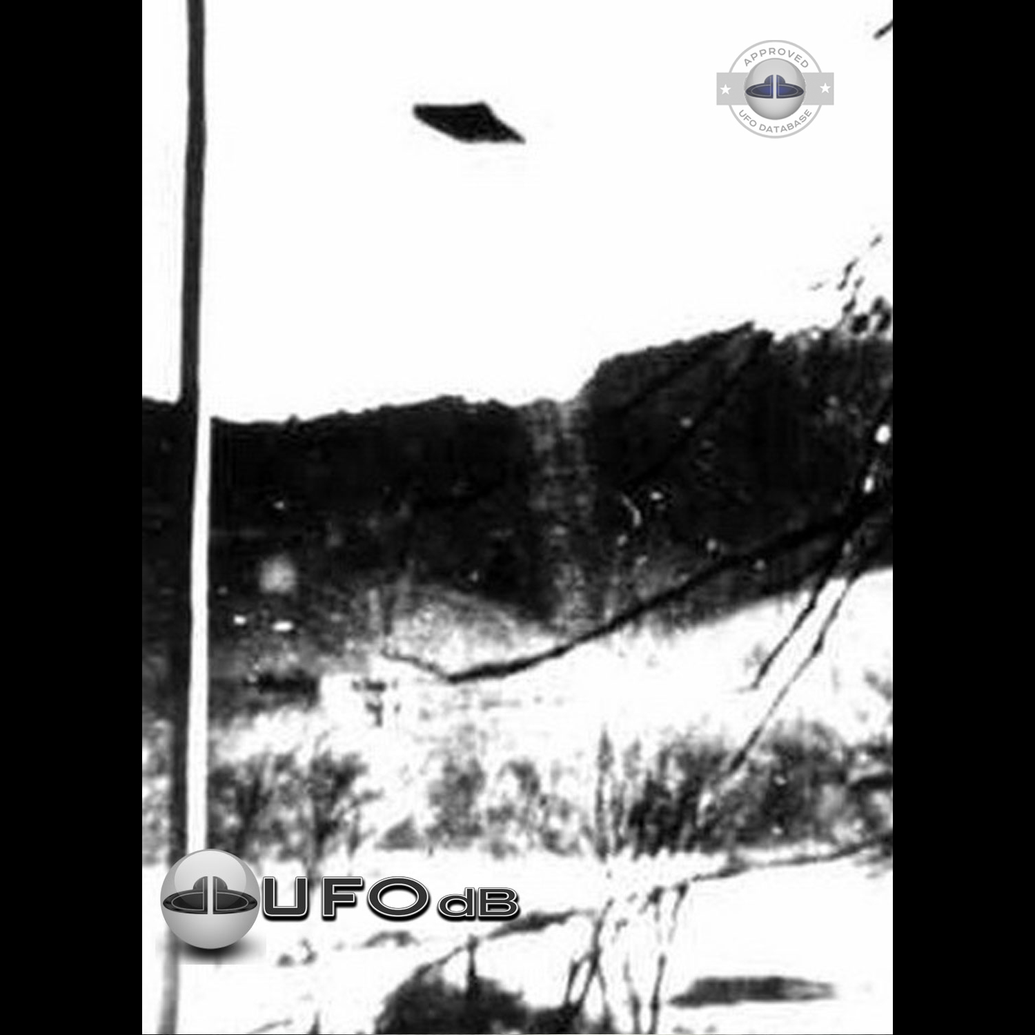 UFO seen over mountain and forest with seem to be snow on the ground UFO Picture #75-1