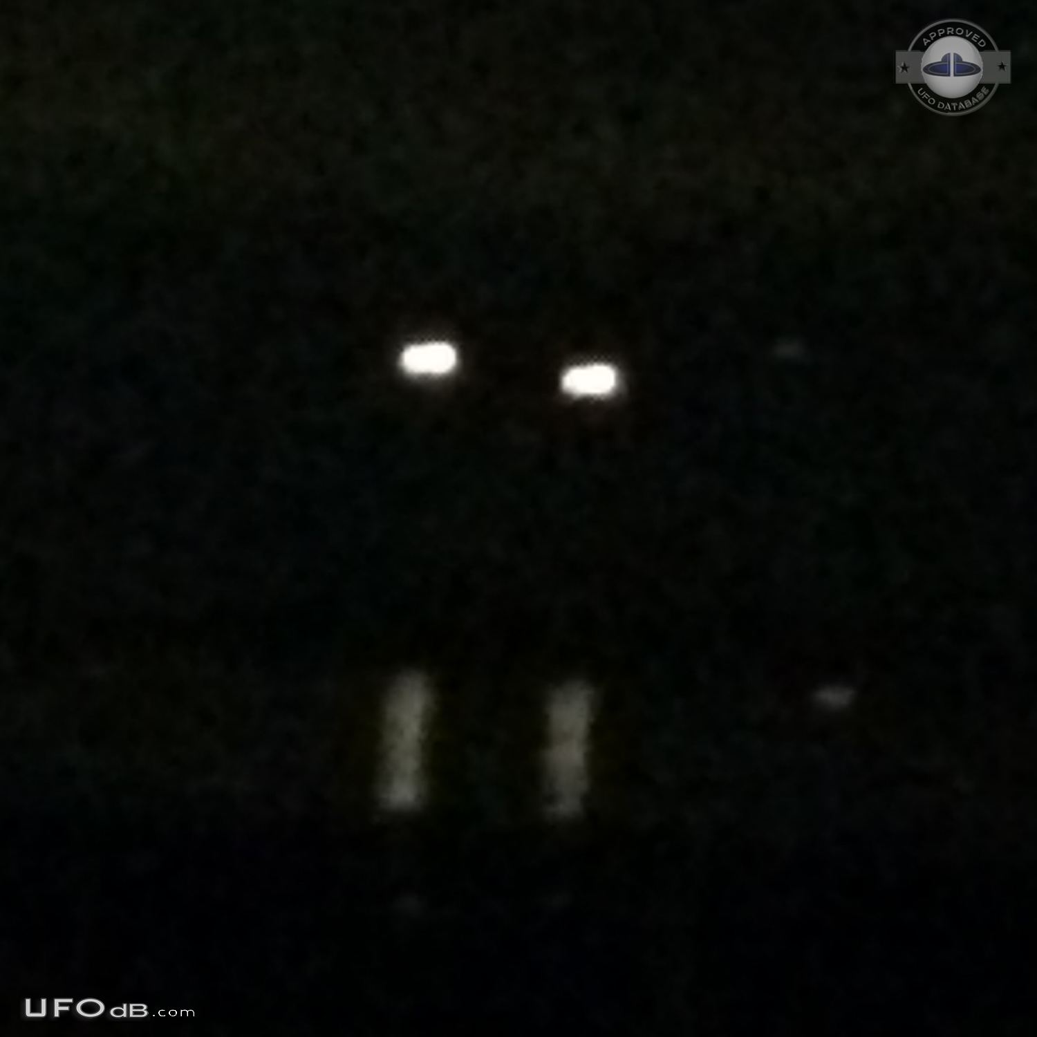 Yellowish-white UFOs with hints of red at center hovered - Clinton Was UFO Picture #755-1